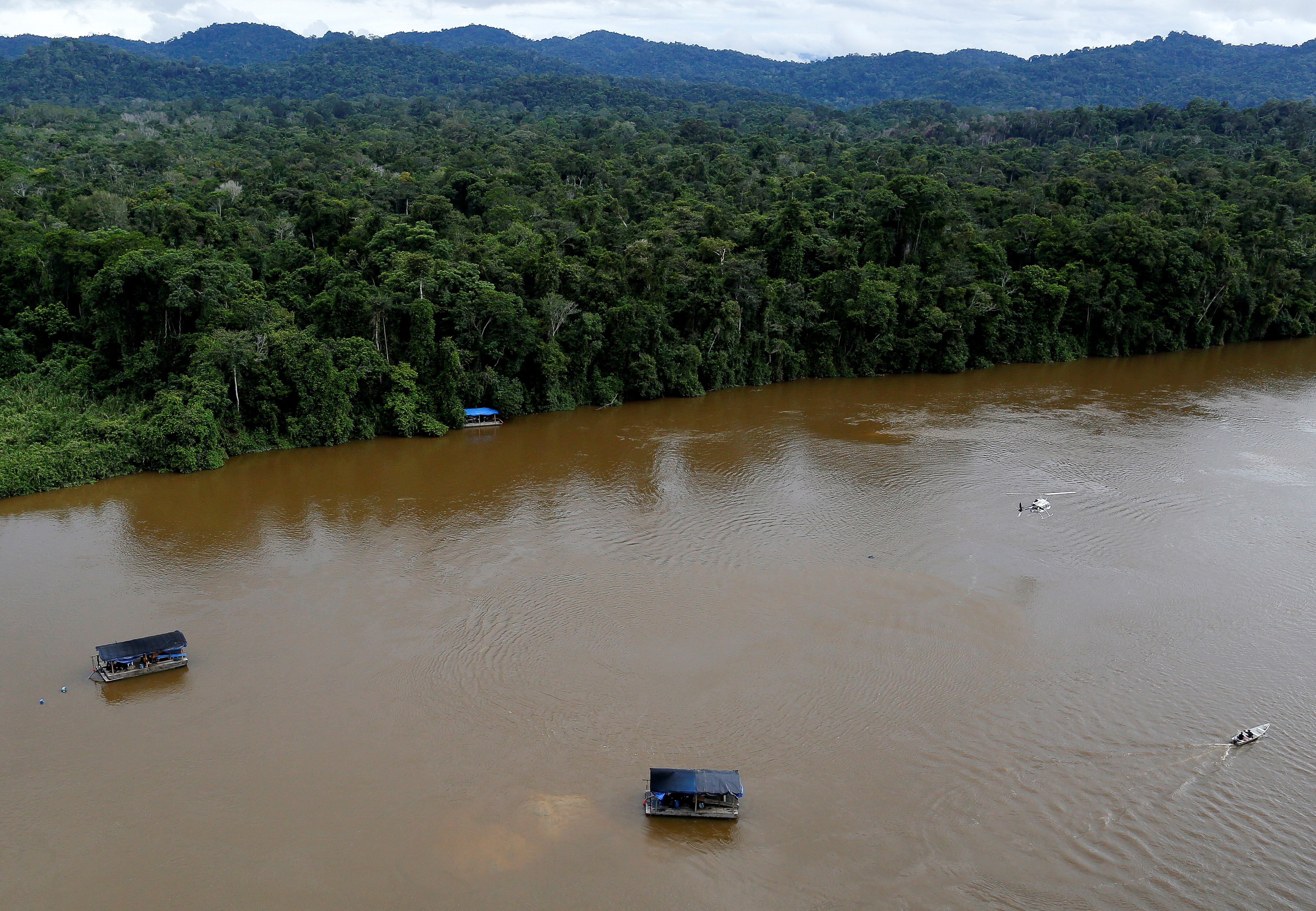 A gold dredge is seen at the banks of Uraricoera River during Brazil's environmental agency operation against illegal gold mining on indigenous land, in the heart of the Amazon rainforest