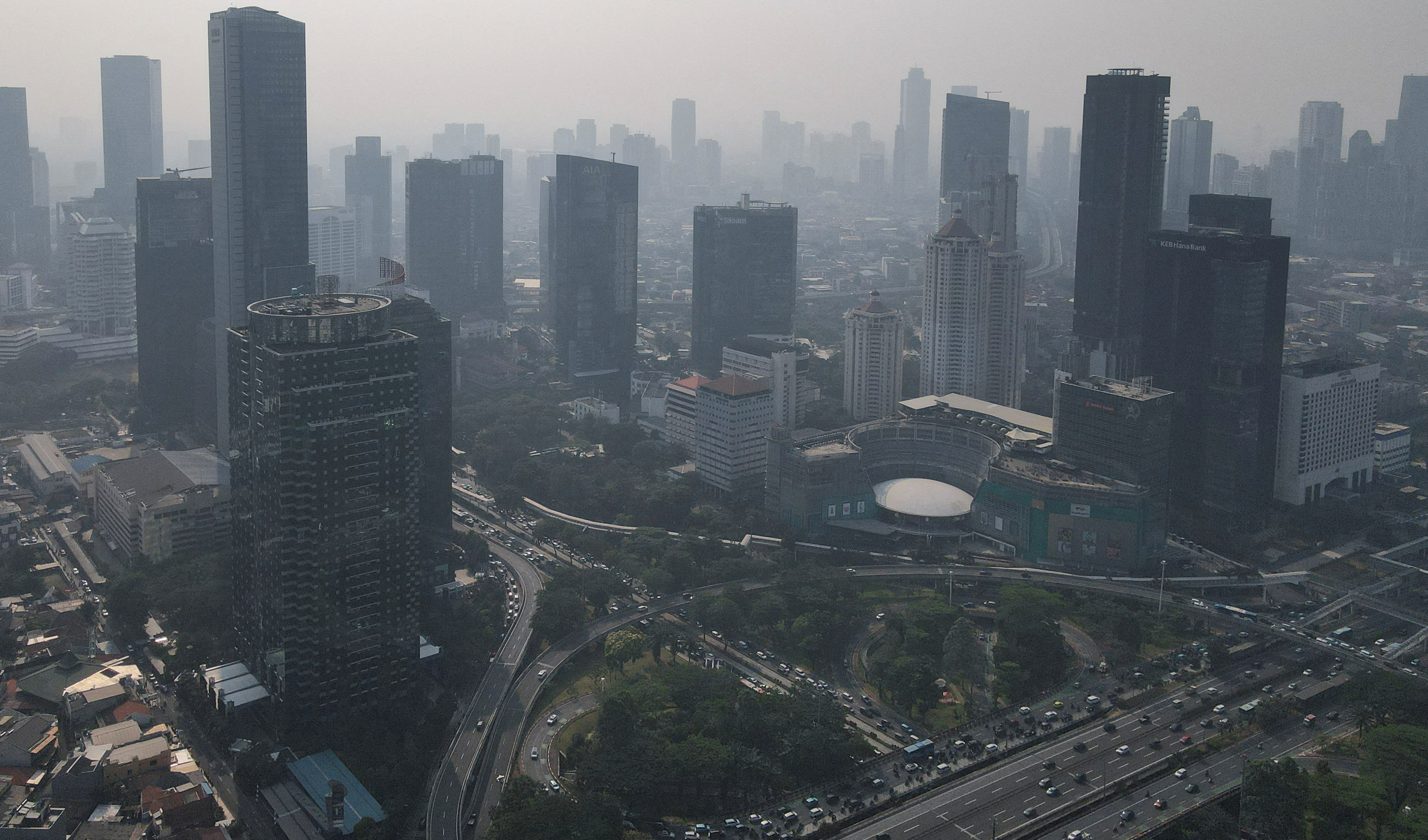 General view of high-rise buildings shrouded in smog in Jakarta