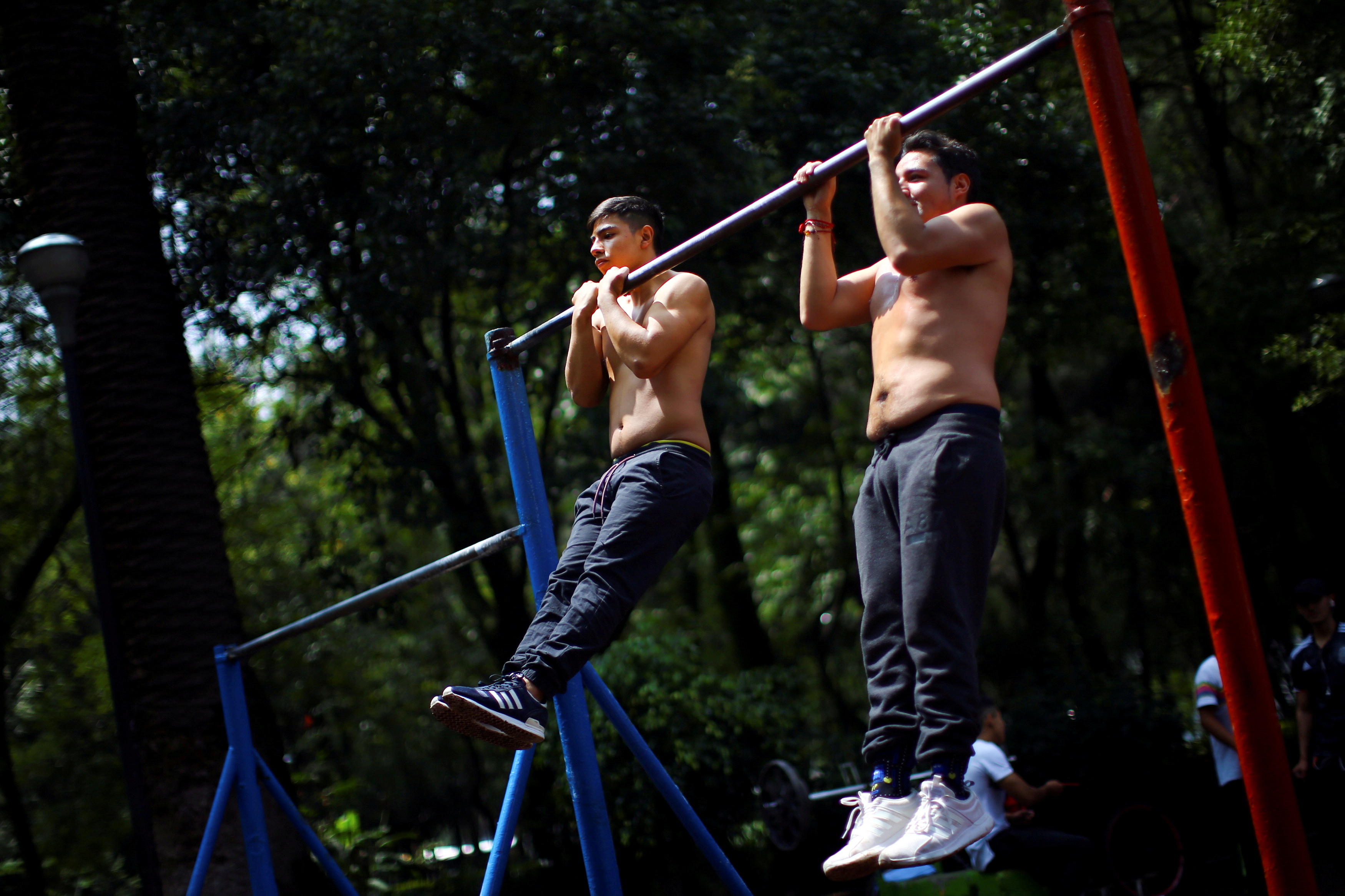 Men exercise in a public park in Mexico City