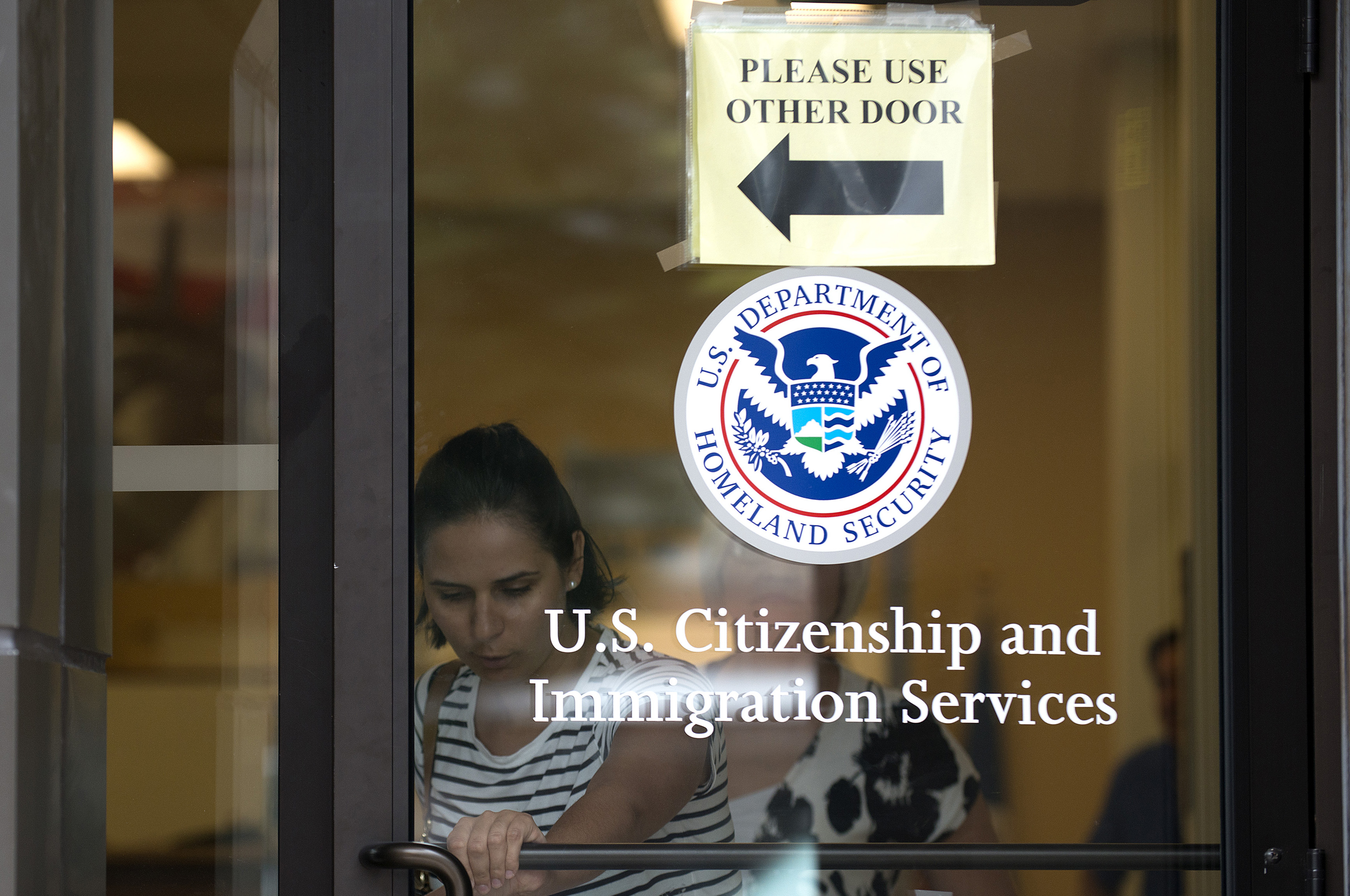 A woman leaves the U.S. Citizenship and Immigration Services offices in New York