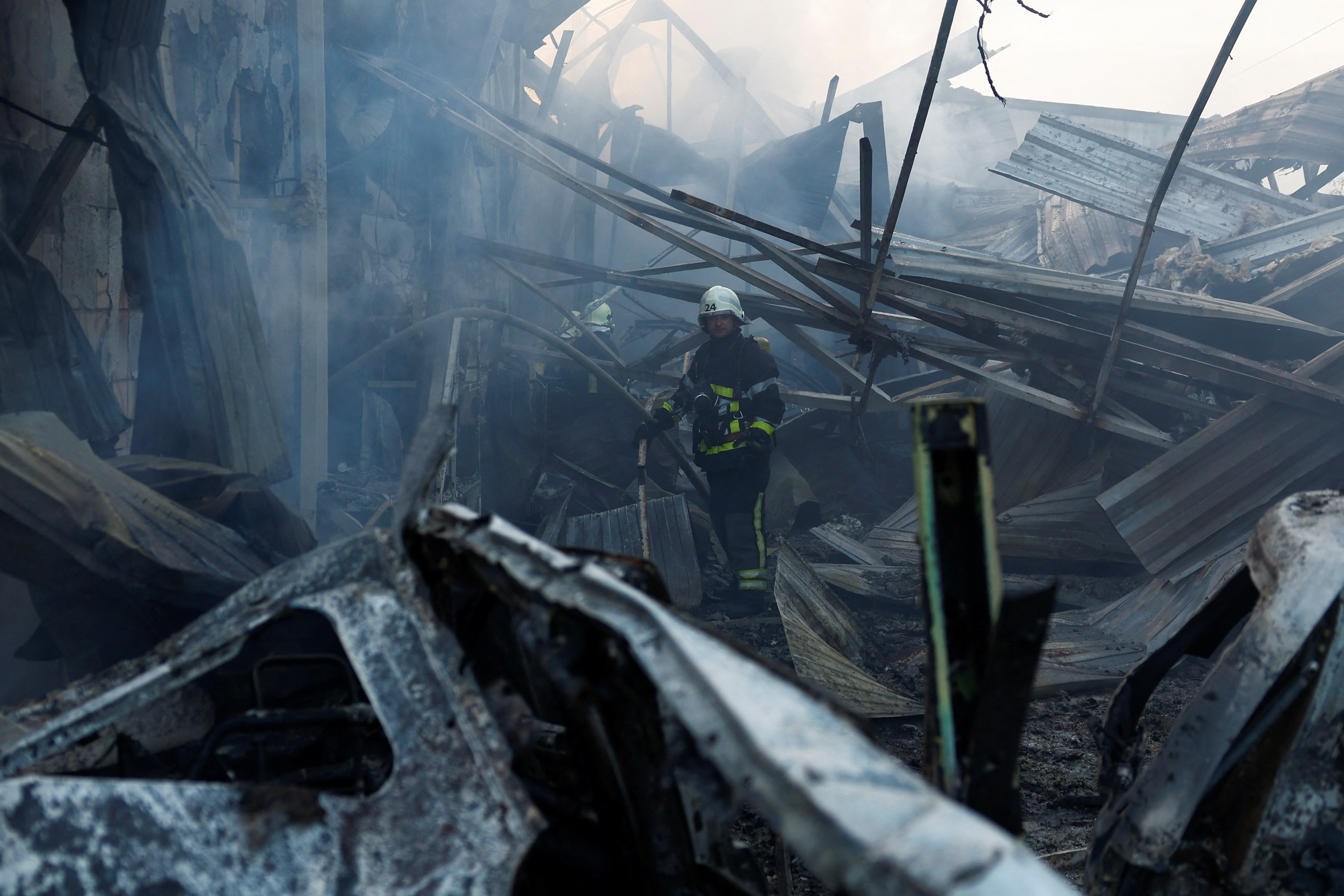 Firefighters work at a site damaged during a Russian missile strike, in Kyiv
