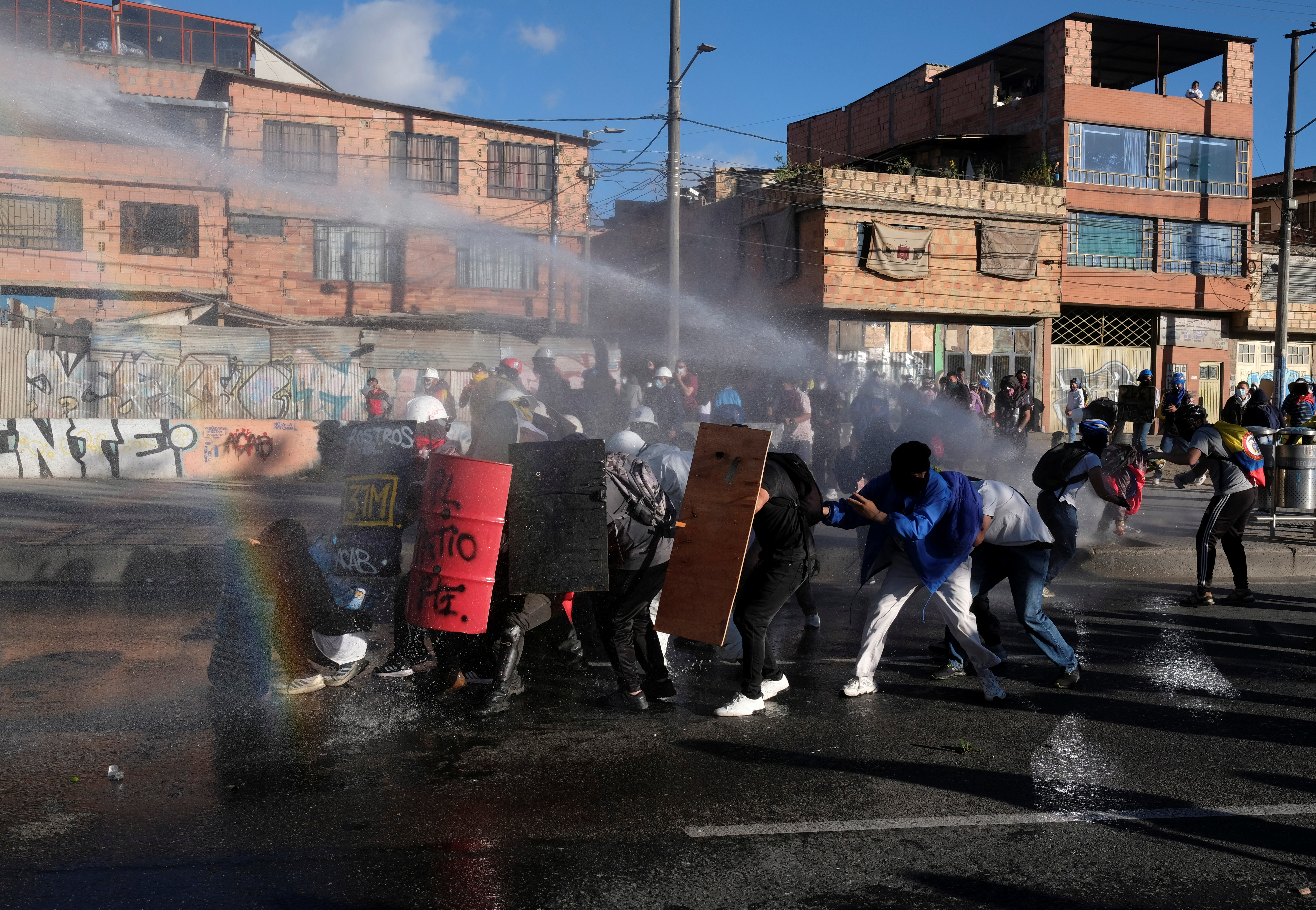 Demonstrators and riot police clash during anti-government protests, as Colombia commemorates Independence Day, in Bogota