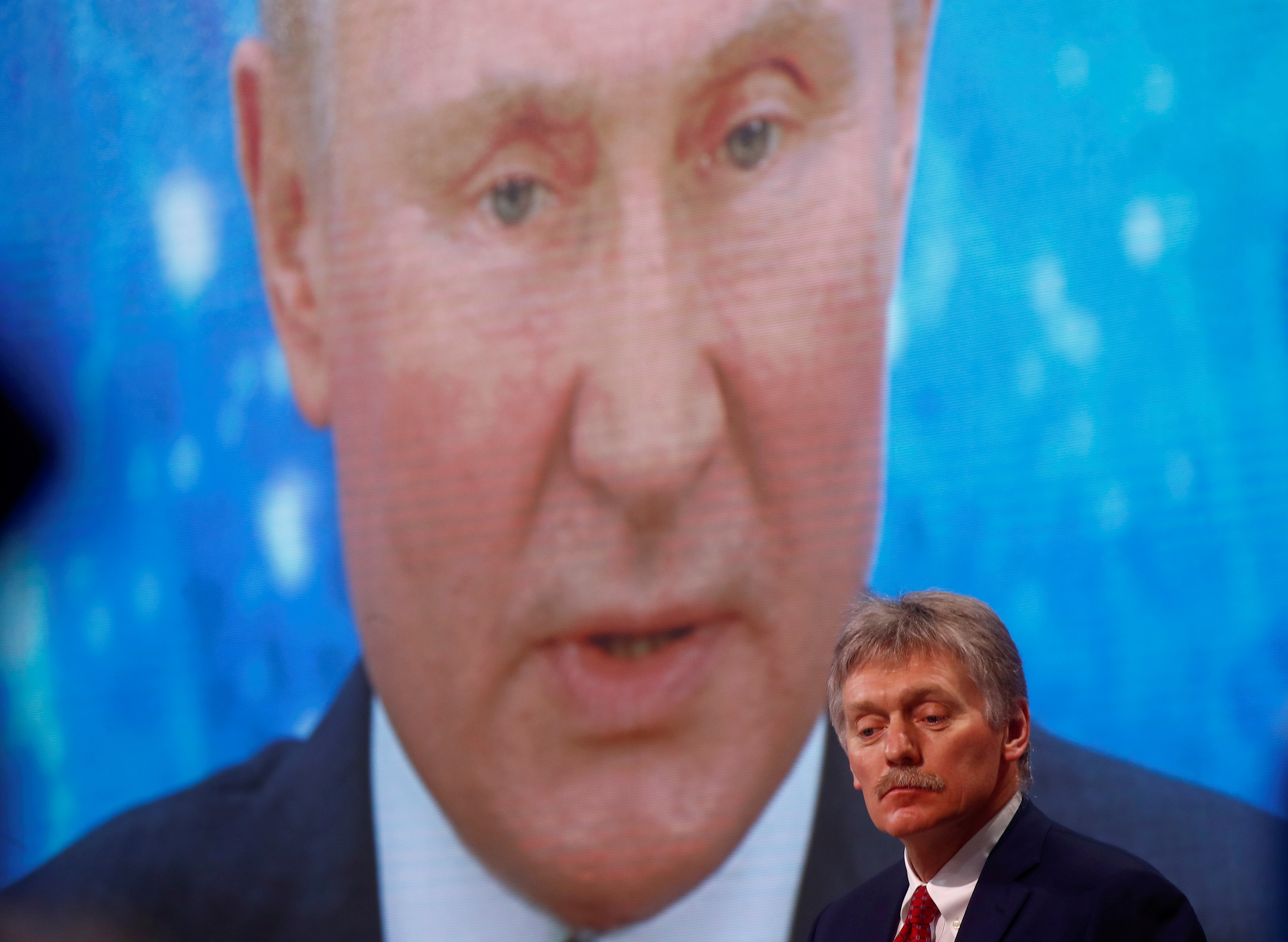 Kremlin spokesman Dmitry Peskov sits in front of an electronic screen during Russian President Vladimir Putin's annual news conference at the end of the year, held online in video conferencing mode, in Moscow, Russia on December 17, 2020. REUTERS / Maxim Shemetov / File Photo