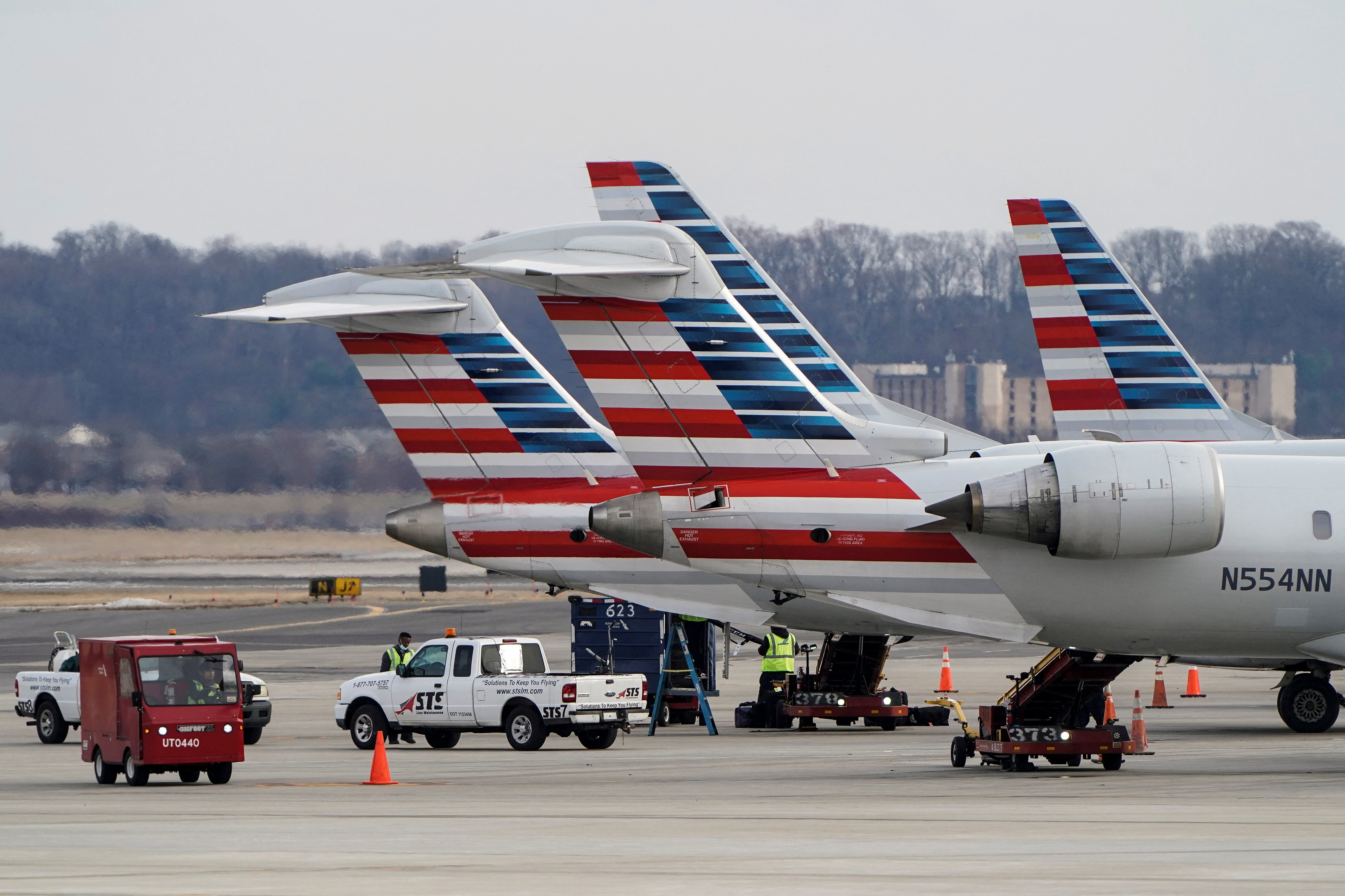 Grounds crews work around American Airlines aircraft at Reagan National Airport in Arlington, Virginia