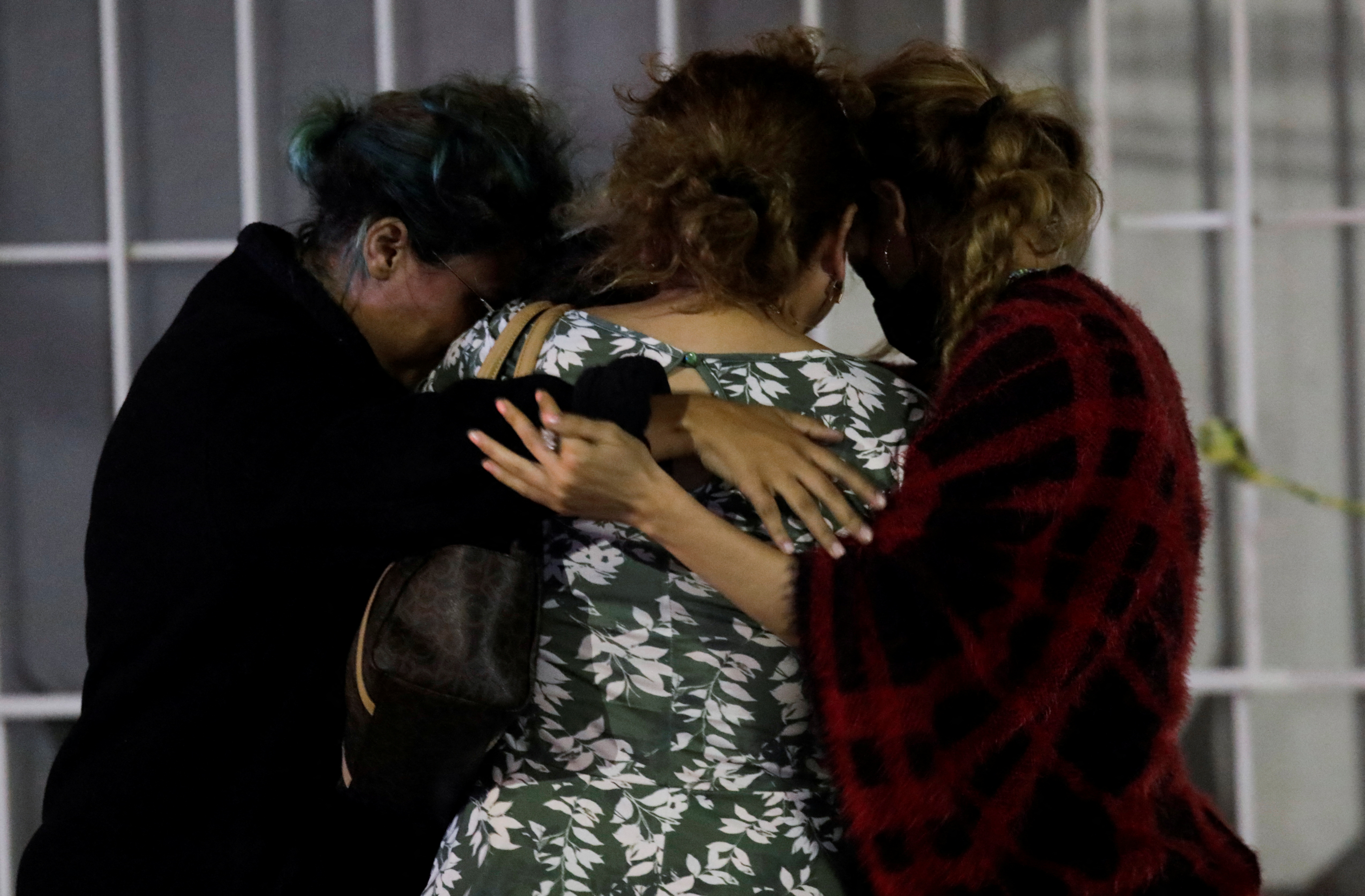 Dolores Bazaldua, mother of 18-year old missing student Debanhi Escobar, is embraced by her family and friends outside the Nueva Castilla motel after authorities found the body of a woman in a water tank, which she says belongs to her daughter, in Escobed