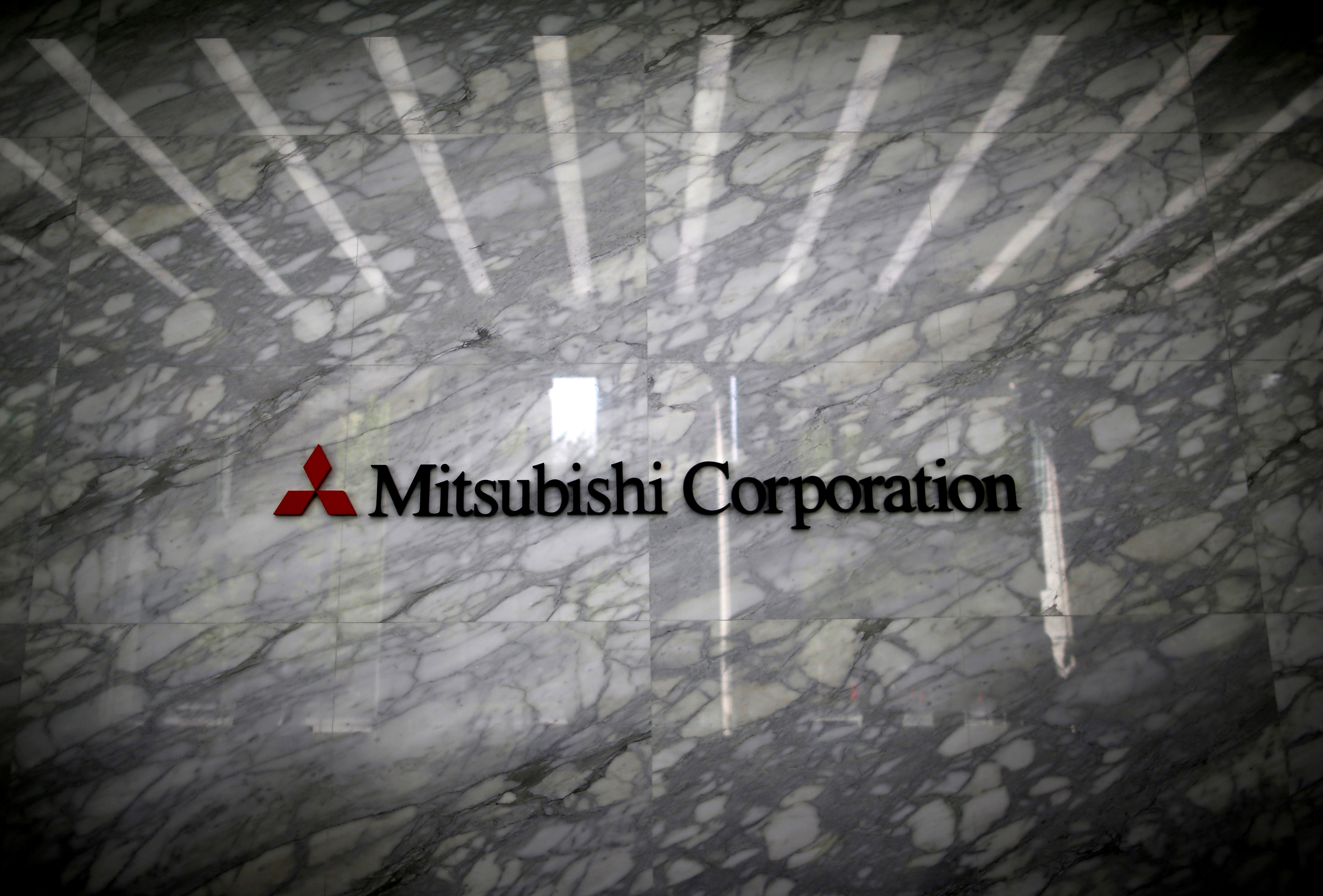 The logo of Mitsubishi Corporation is displayed at the entrance of the company headquarters building in Tokyo