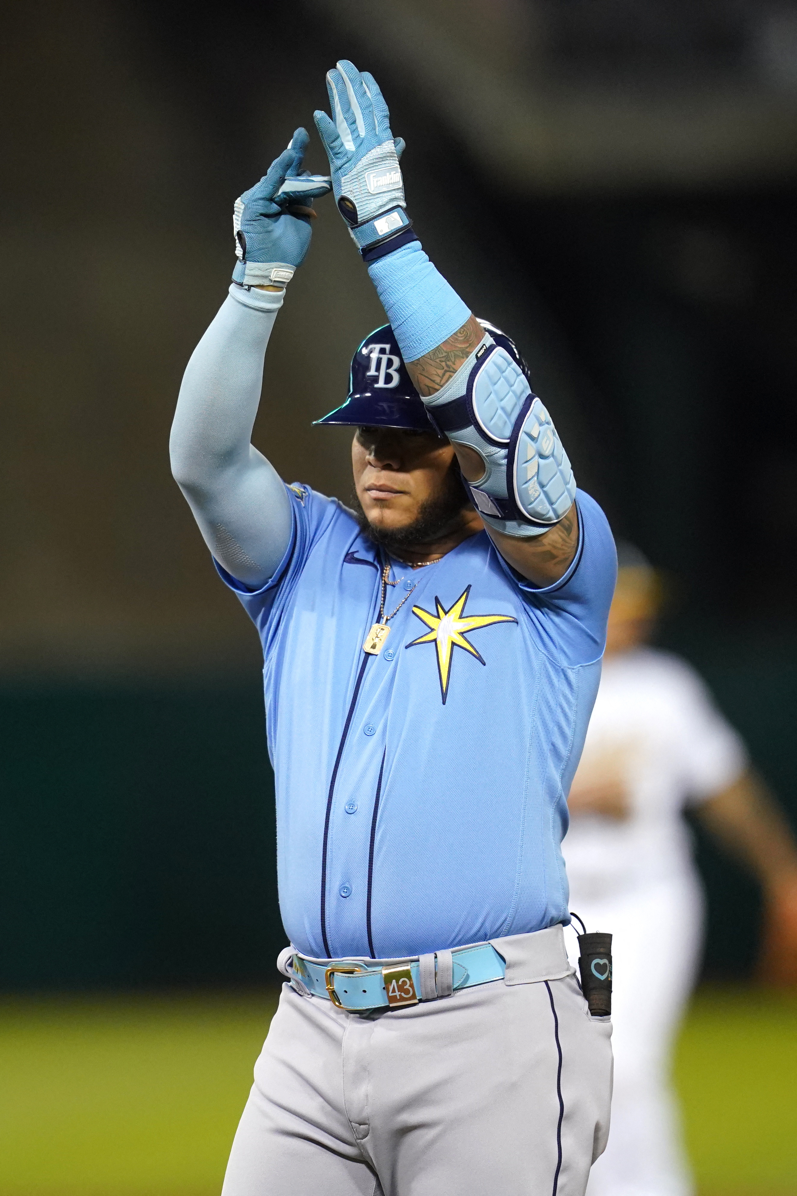 Tampa Bay Rays' Josh Lowe, left, tugs on the jersey of his brother