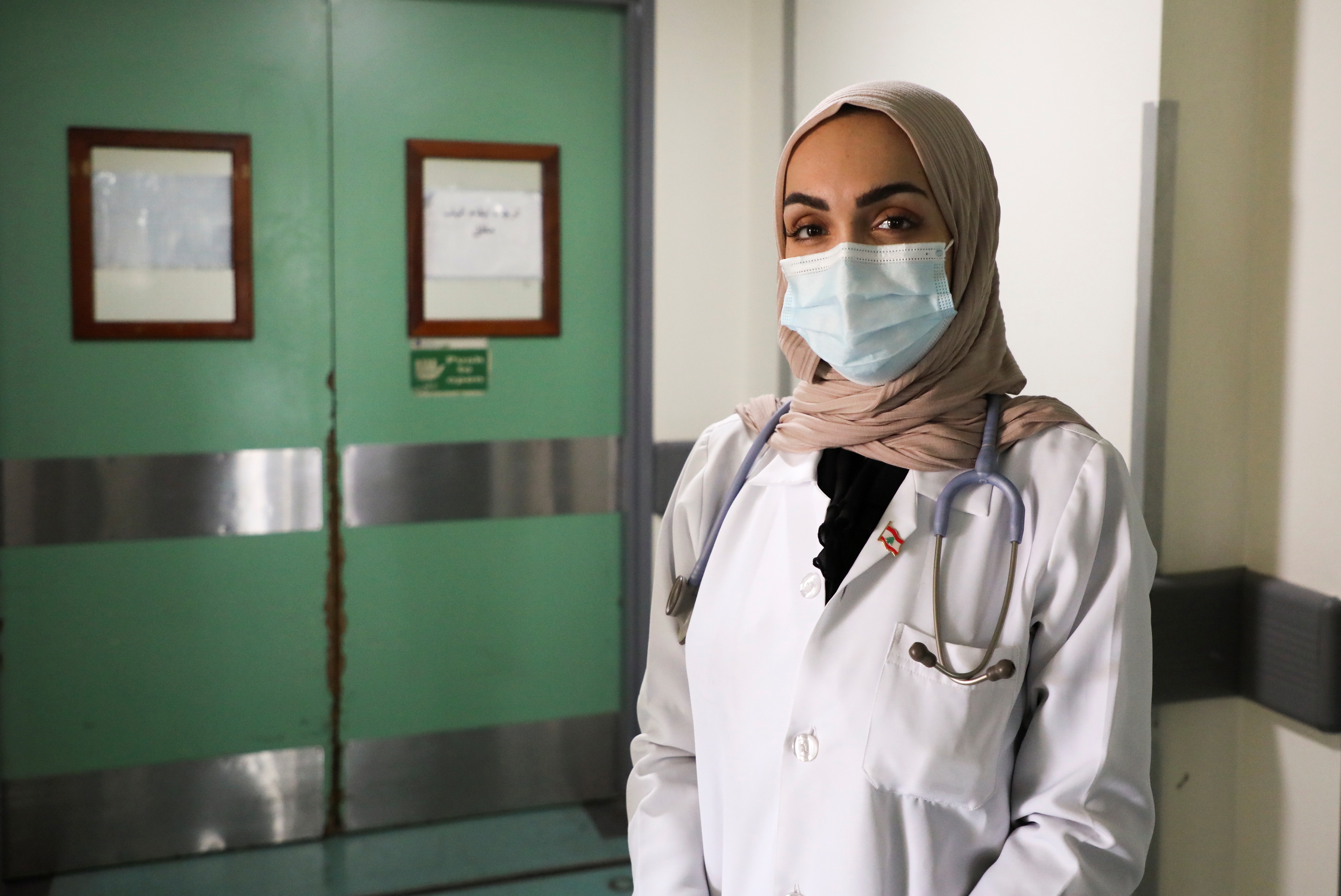 Israa Seblani, a Lebanese doctor and the bride who was caught up in the last year's Beirut port blast during a wedding photoshoot, poses at Rafik Hariri University Hospital, in Beirut