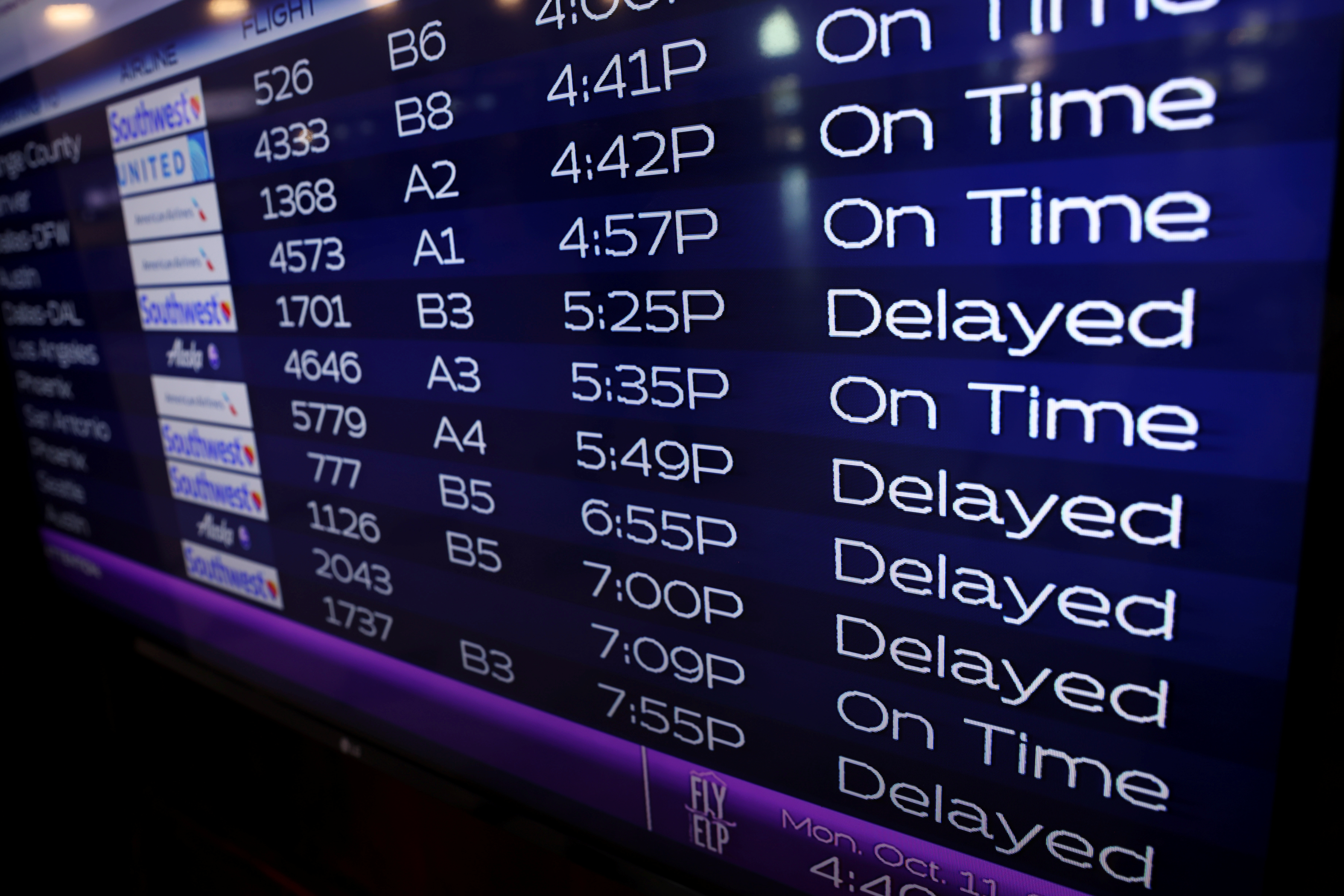 Southwest flight are shown as delayed on the departure screen at the airport in El Paso, Texas, U.S., October 11, 2021.  REUTERS/Mike Blake