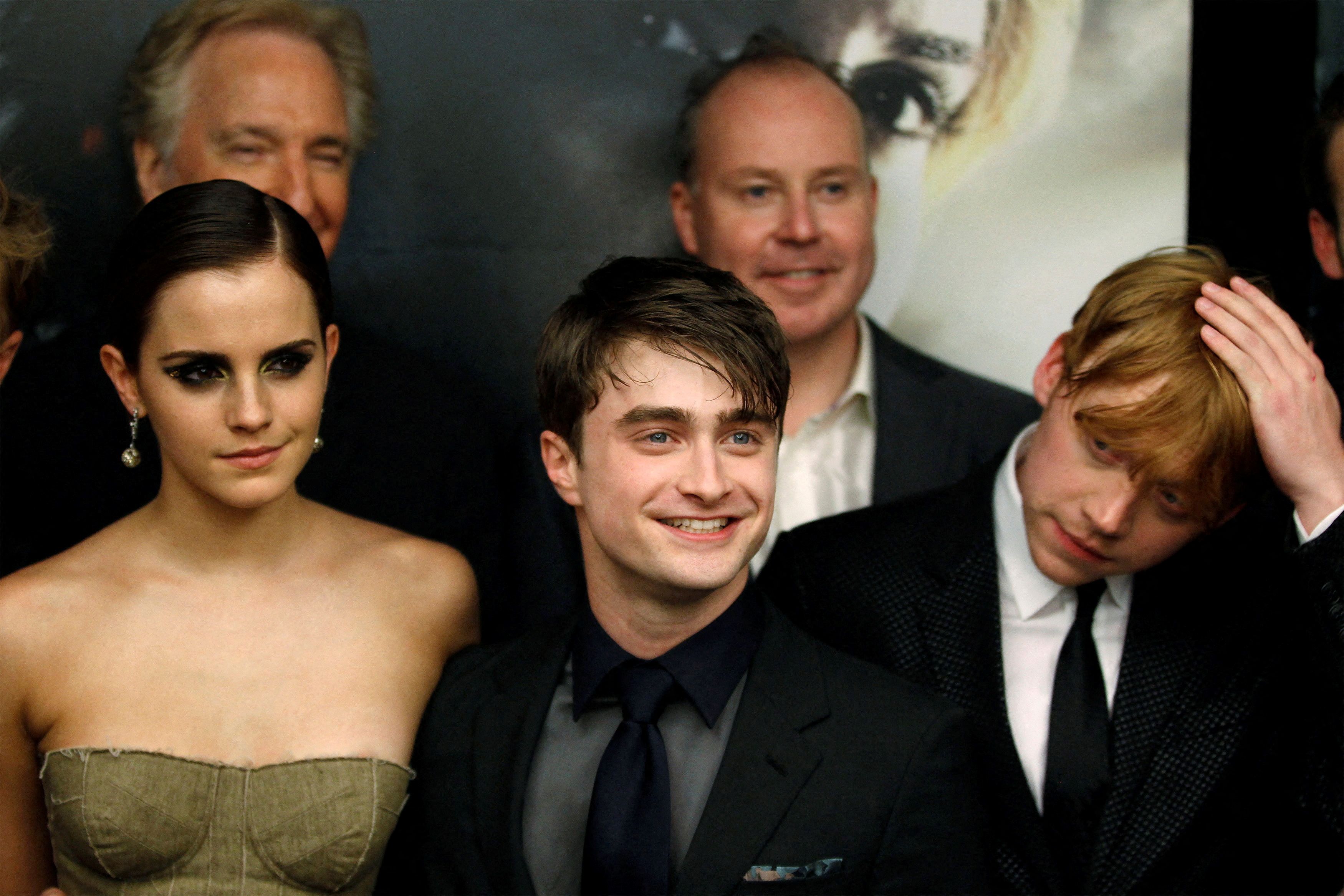 Cast members Rupert Grint (R), Daniel Radcliffe and Emma Watson (L) arrive for the premiere of the film 