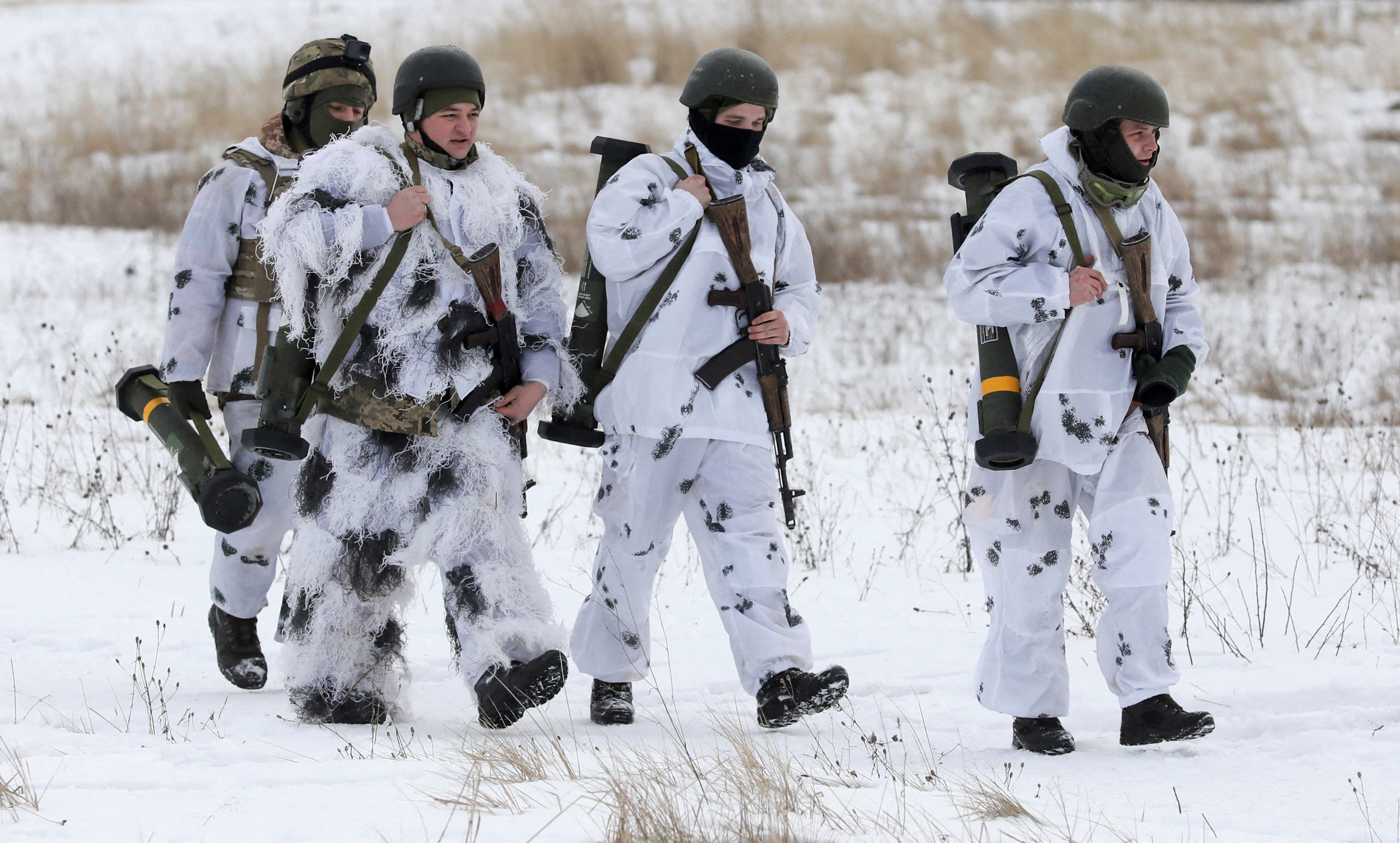 Ukrainian service members walk with M141 Bunker Defeat Munition weapons supplied by the United States during drills at the International Peacekeeping Security Centre near Yavoriv in the Lviv region, Ukraine, February 4, 2022. REUTERS/Roman Baluk/File Photo