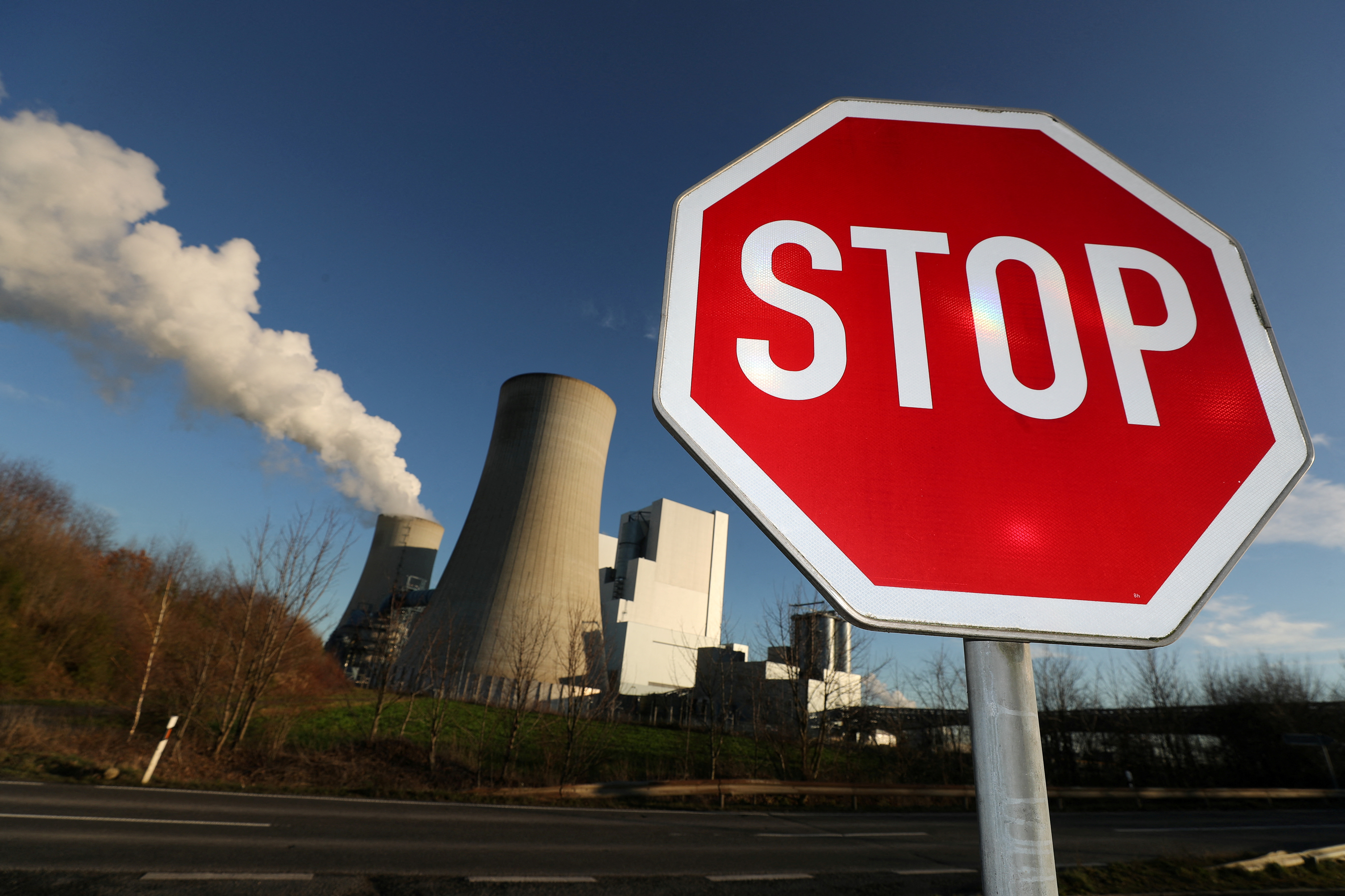 Stop sign stands in front of the Neurath lignite power plant