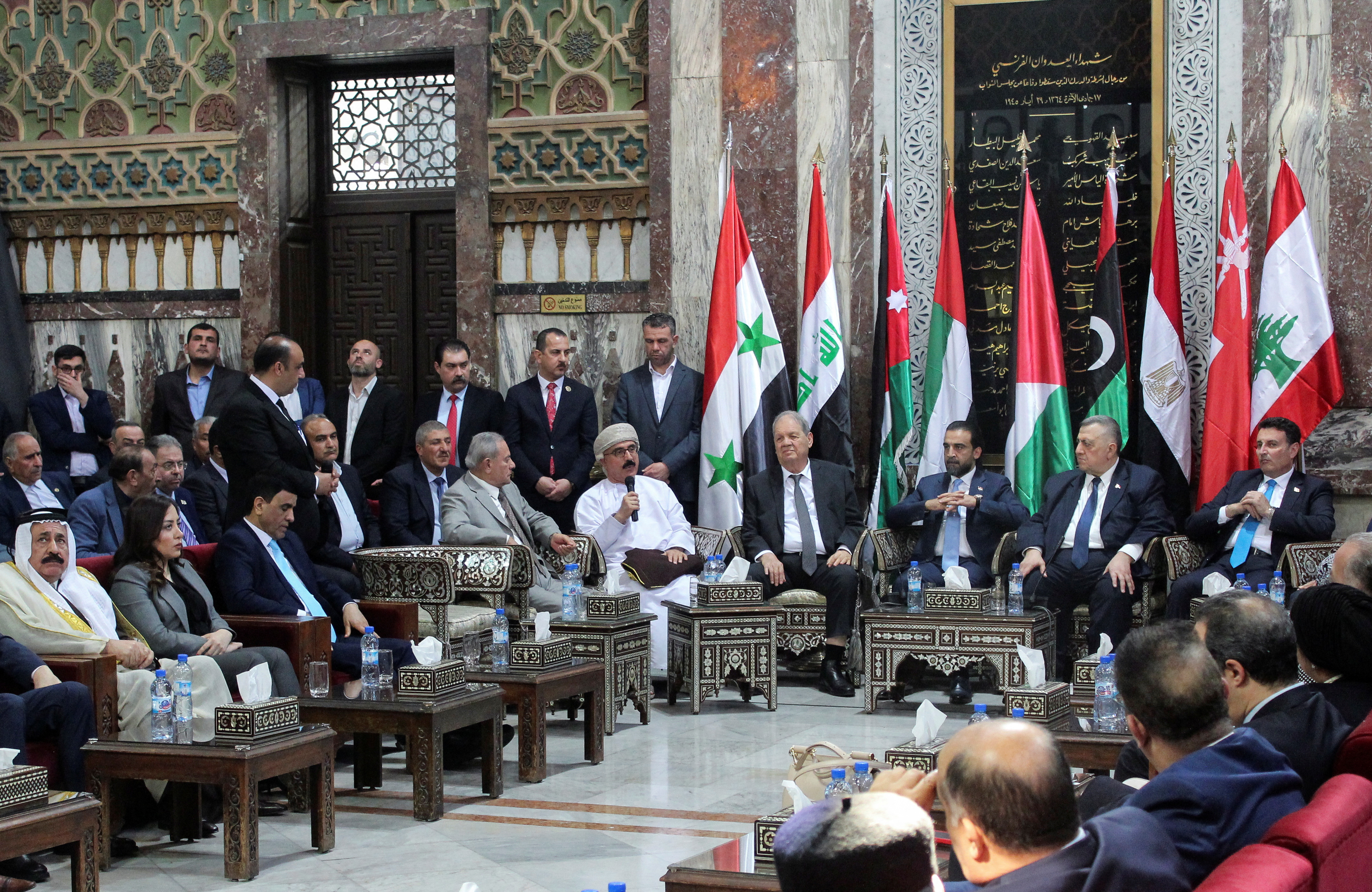 Syrian parliament members meet with a delegation from the Arab Inter-Parliamentary Union in Damascus