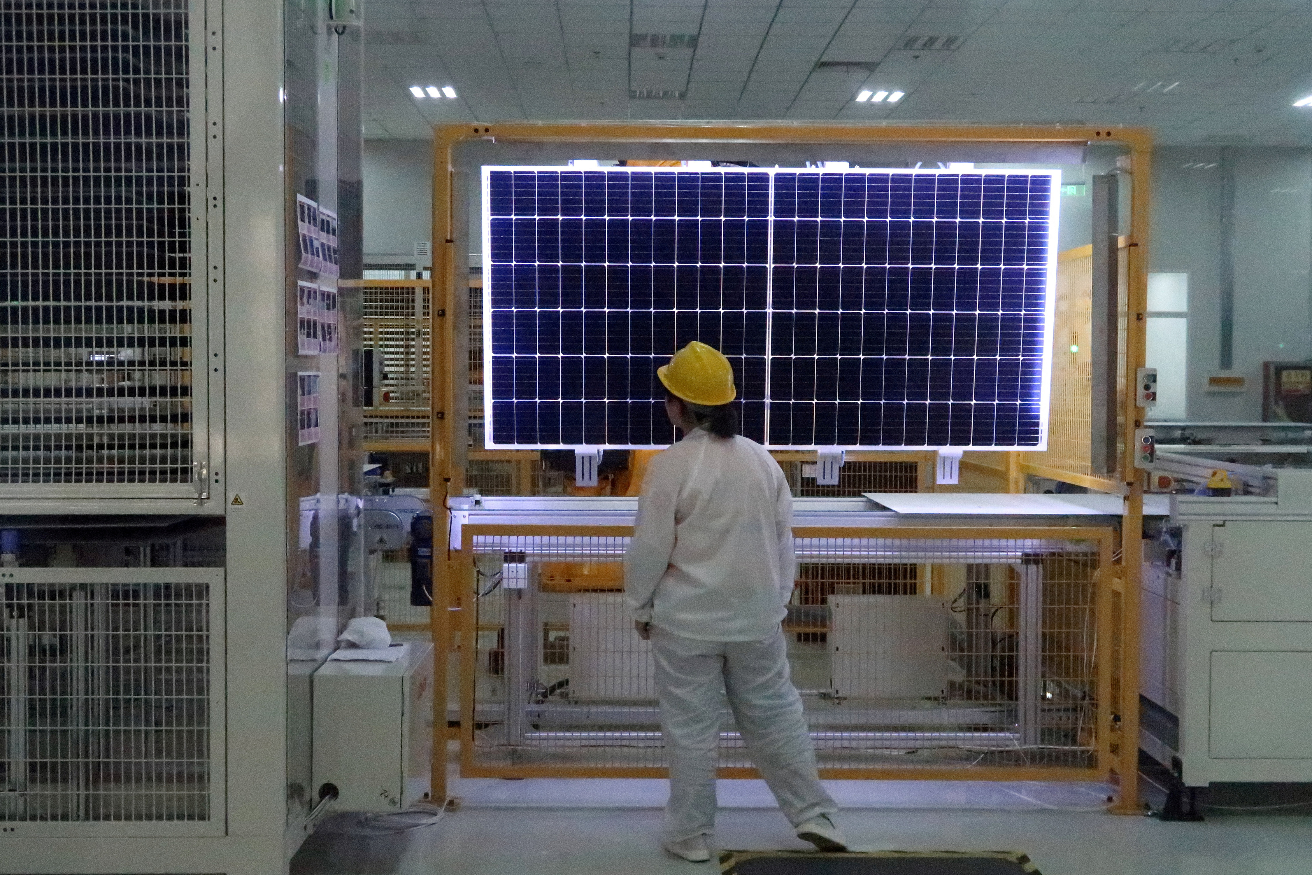 Worker conducts quality-check of a solar module product at a factory of a monocrystalline silicon solar equipment manufacturer in Xian, Shaanxi