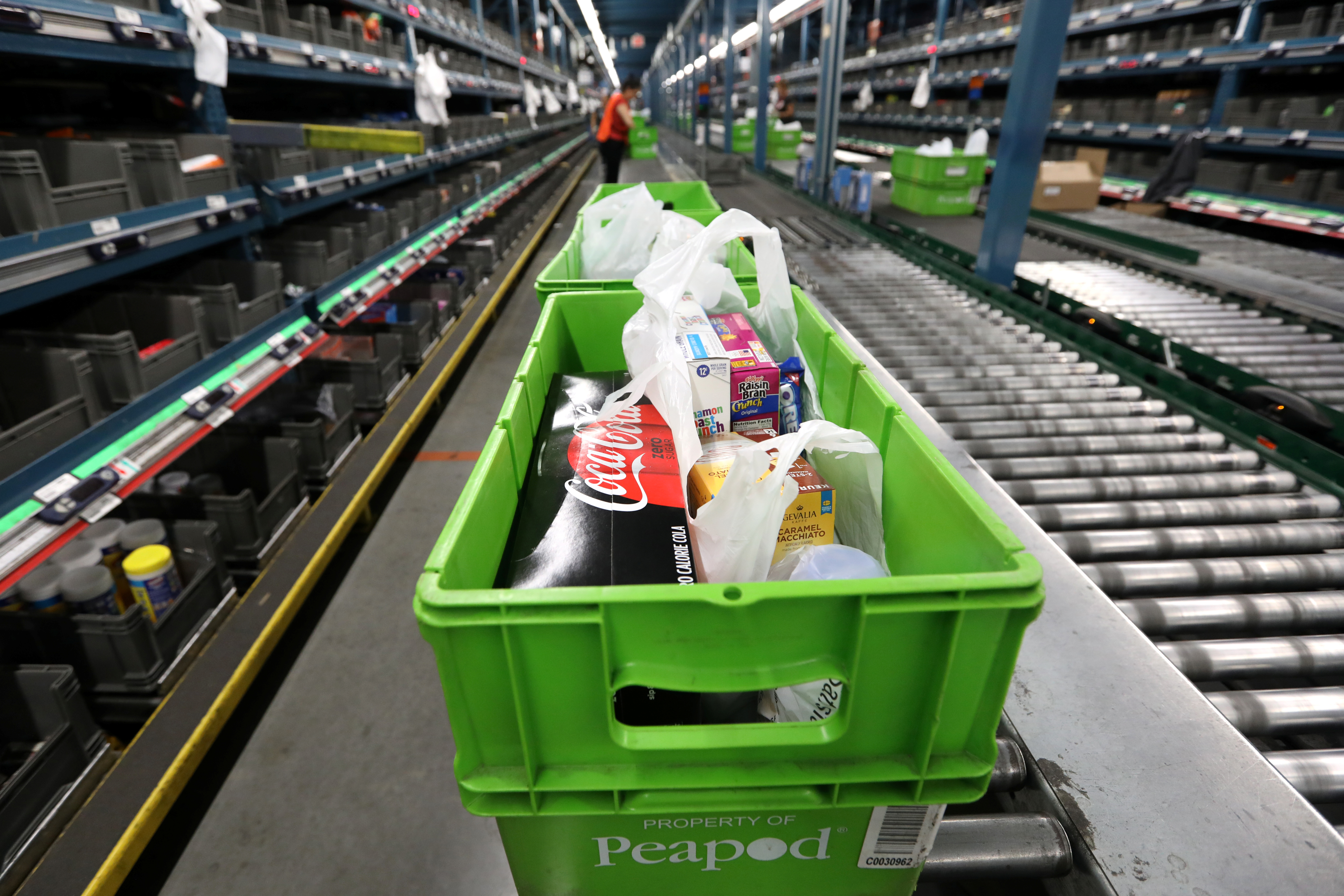 Groceries are seen packed in totes at a Peapod grocery distribution warehouse facility in Jersey City
