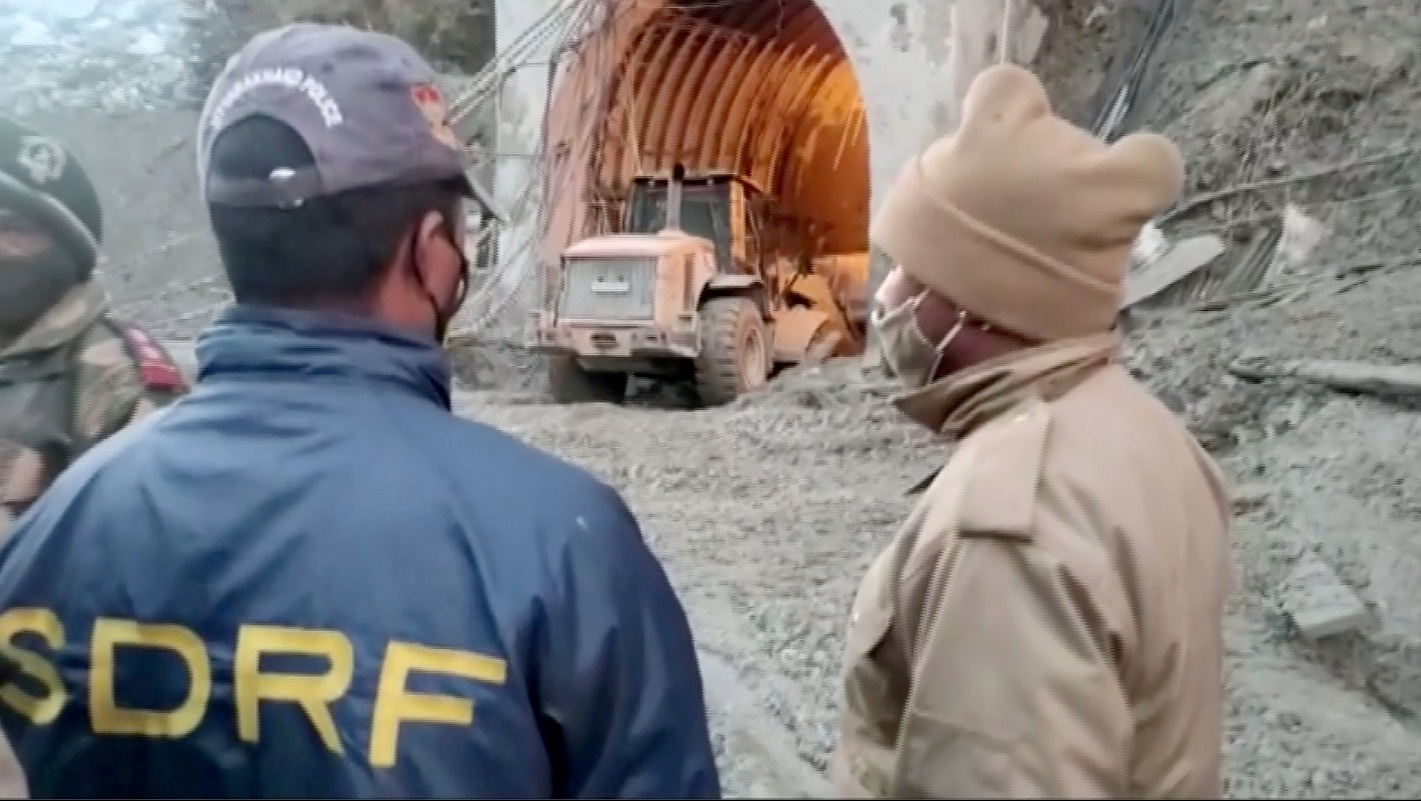 Excavator exits a tunnel in Chamoli, Uttarakhand, India during a rescue operation after a glacier burst, in this still frame taken from video dated February 8, 2021. STATE DISASTER RESPONSE FORCE/via REUTERS TV 