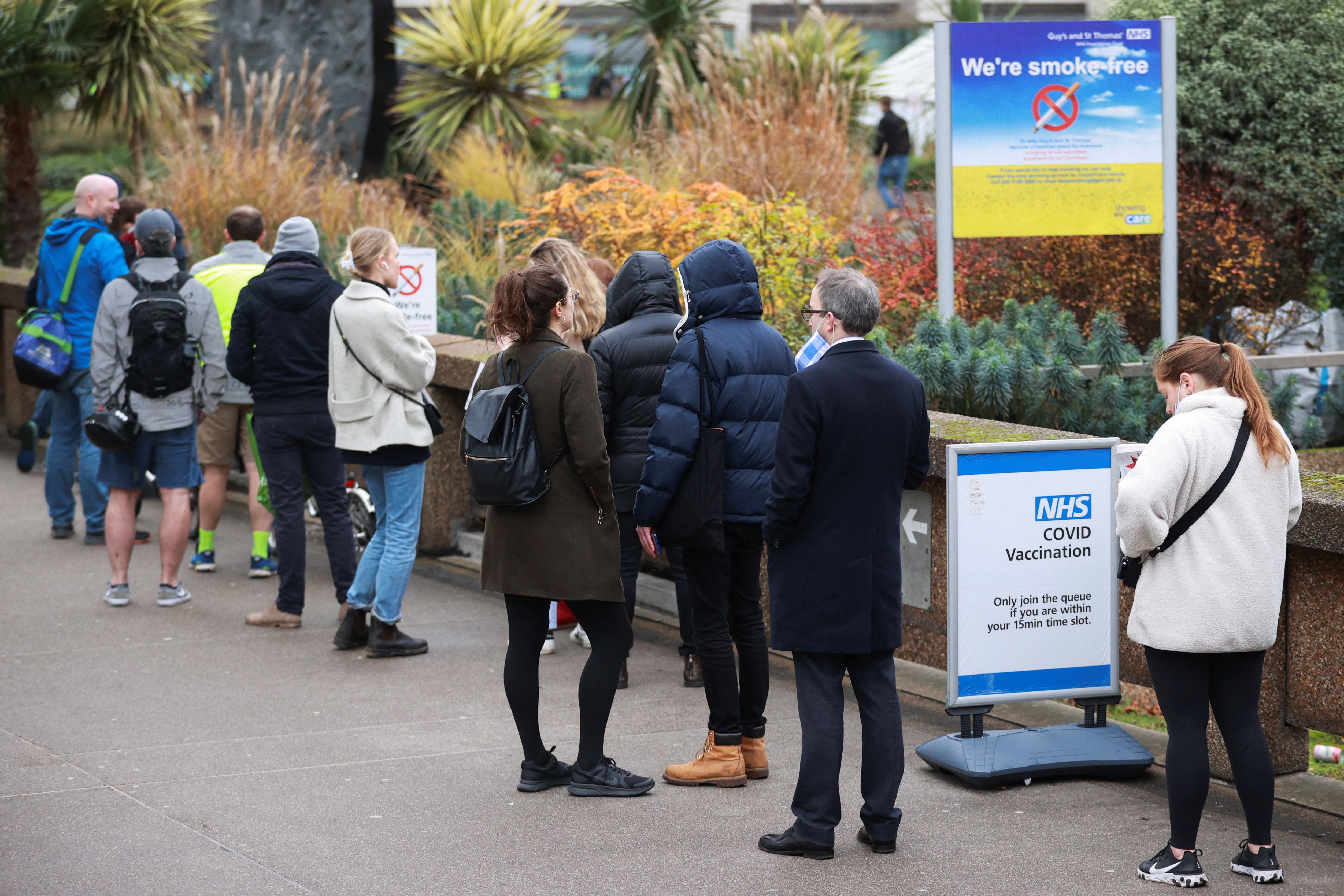 People queue outside a coronavirus disease (COVID-19) vaccination centre at St Thomas's Hospital in London, Britain, December 13, 2021. REUTERS/Hannah McKay