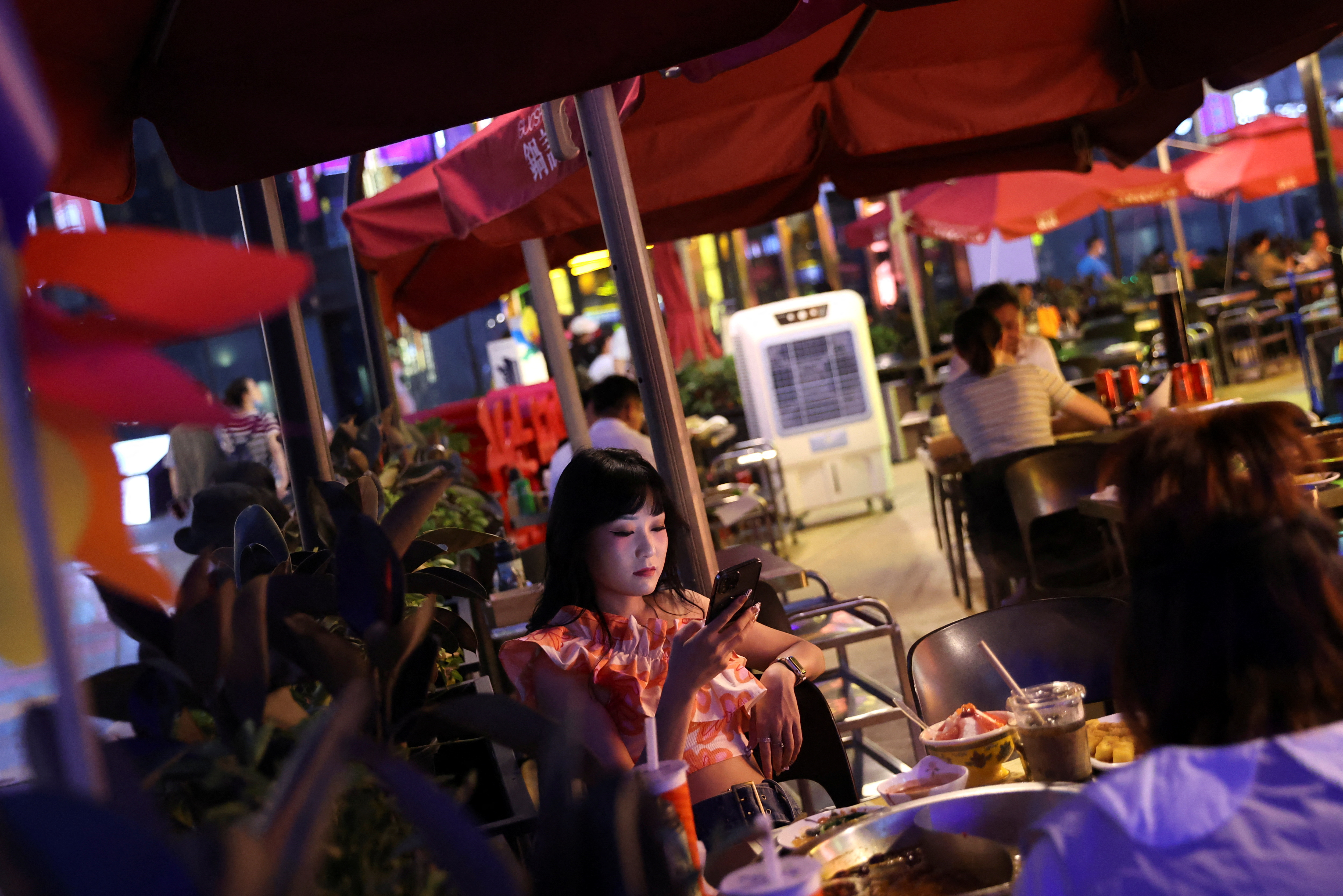 Customers dine at a restaurant at a shopping area in Beijing