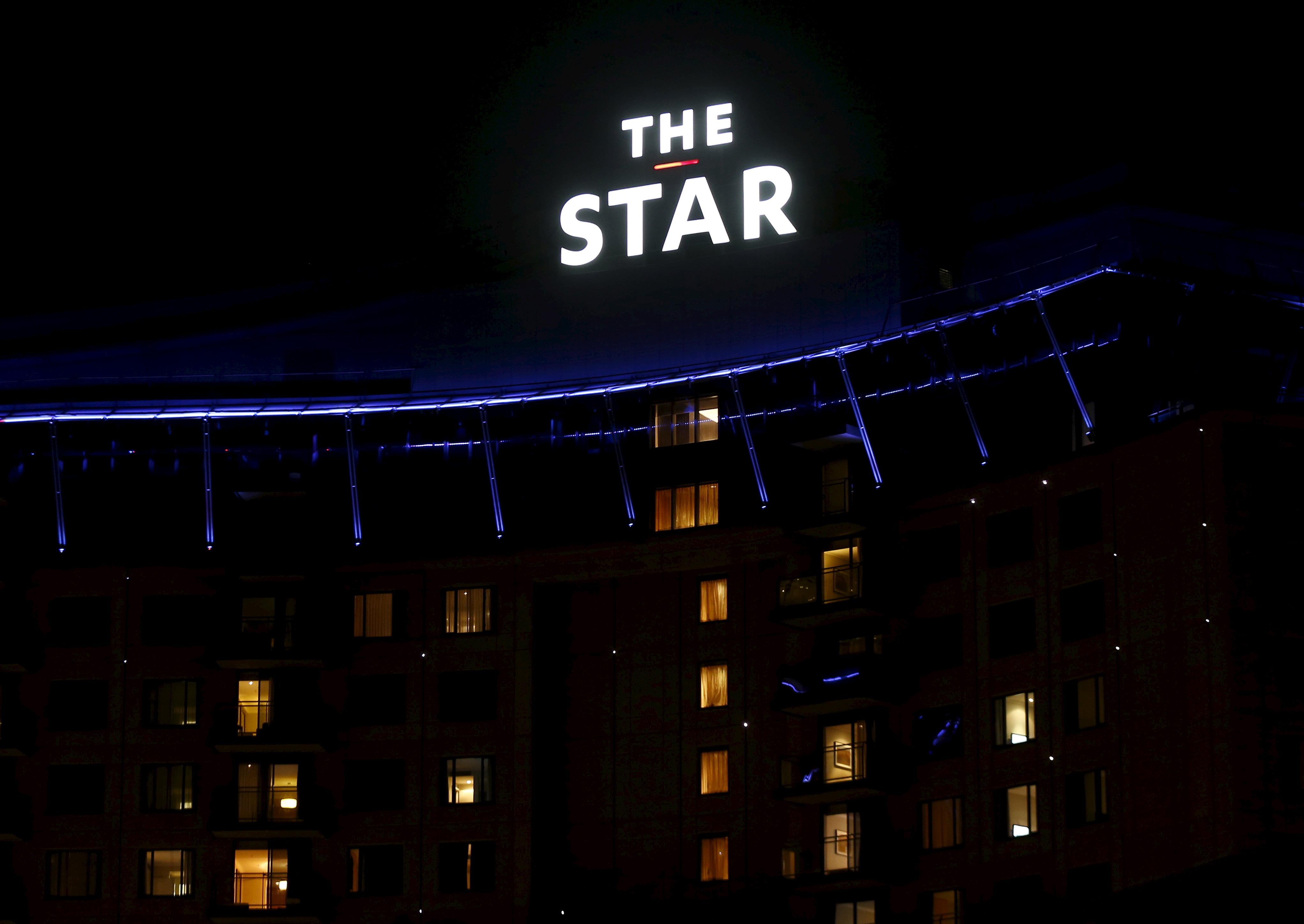 Guest rooms at a hotel above Sydney's Star Casino complex are seen illuminated at night