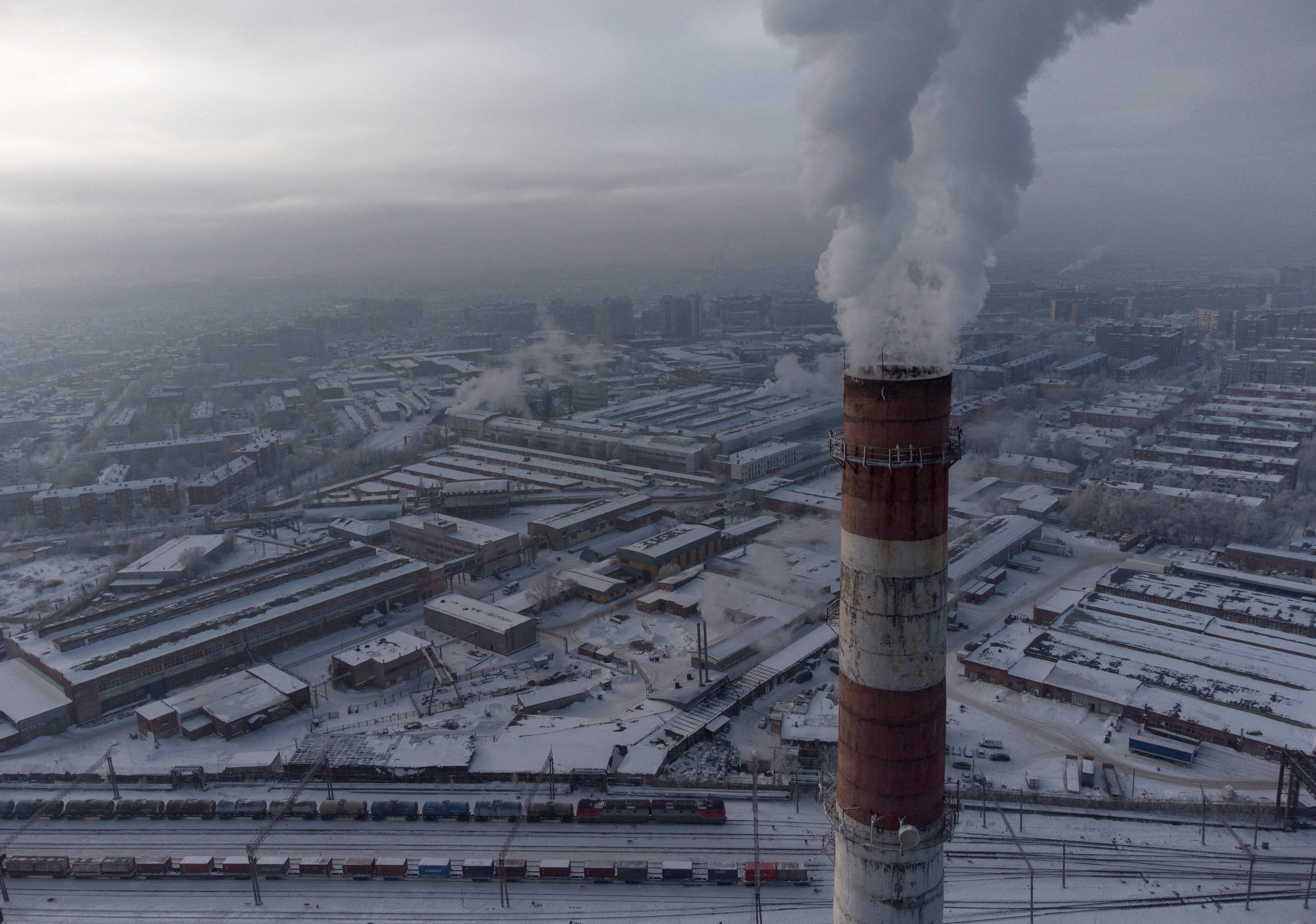 Smoke billows from a chimney in the city of Omsk