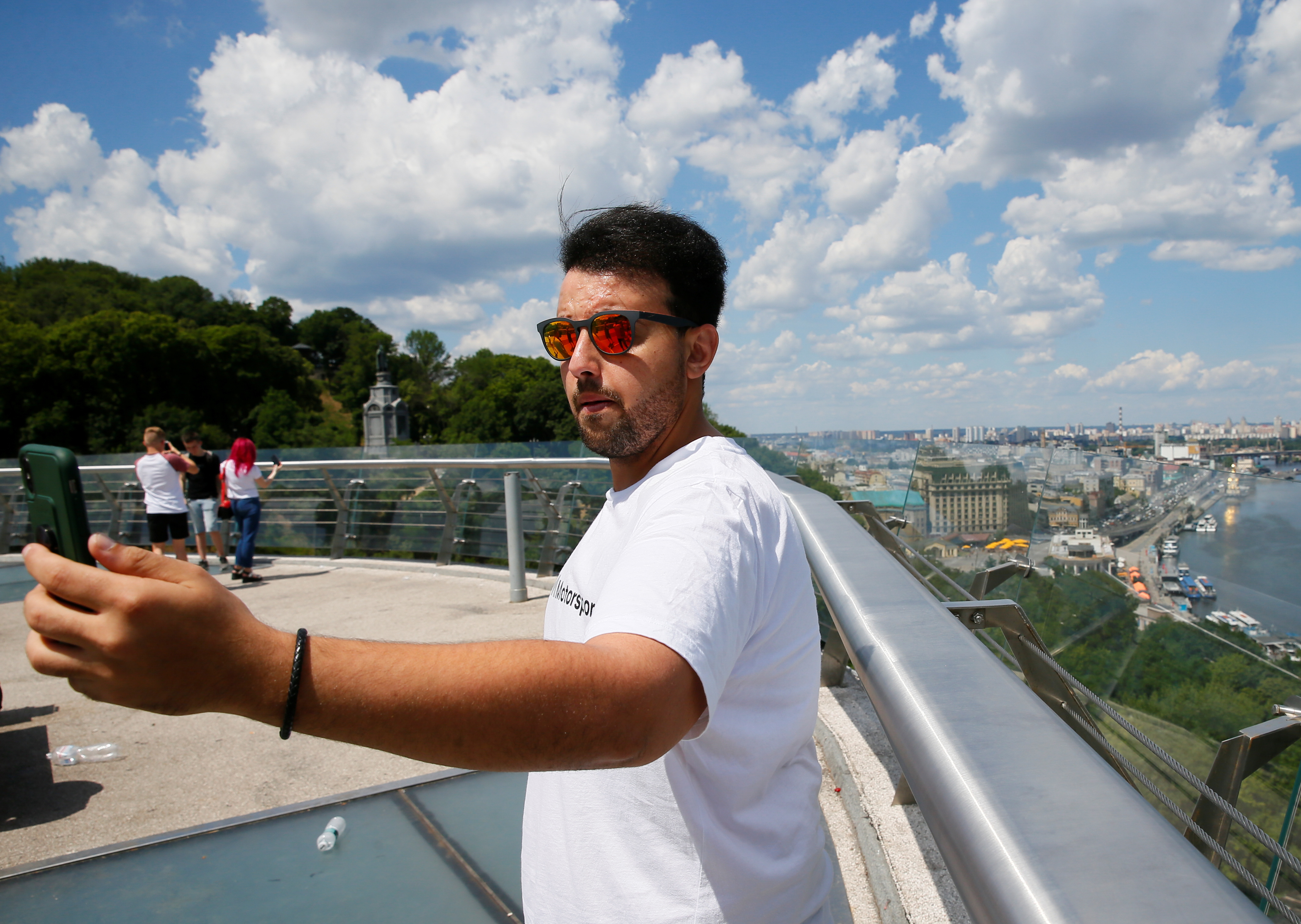 A tourist from Saudi Arabia takes a selfie in central Kyiv