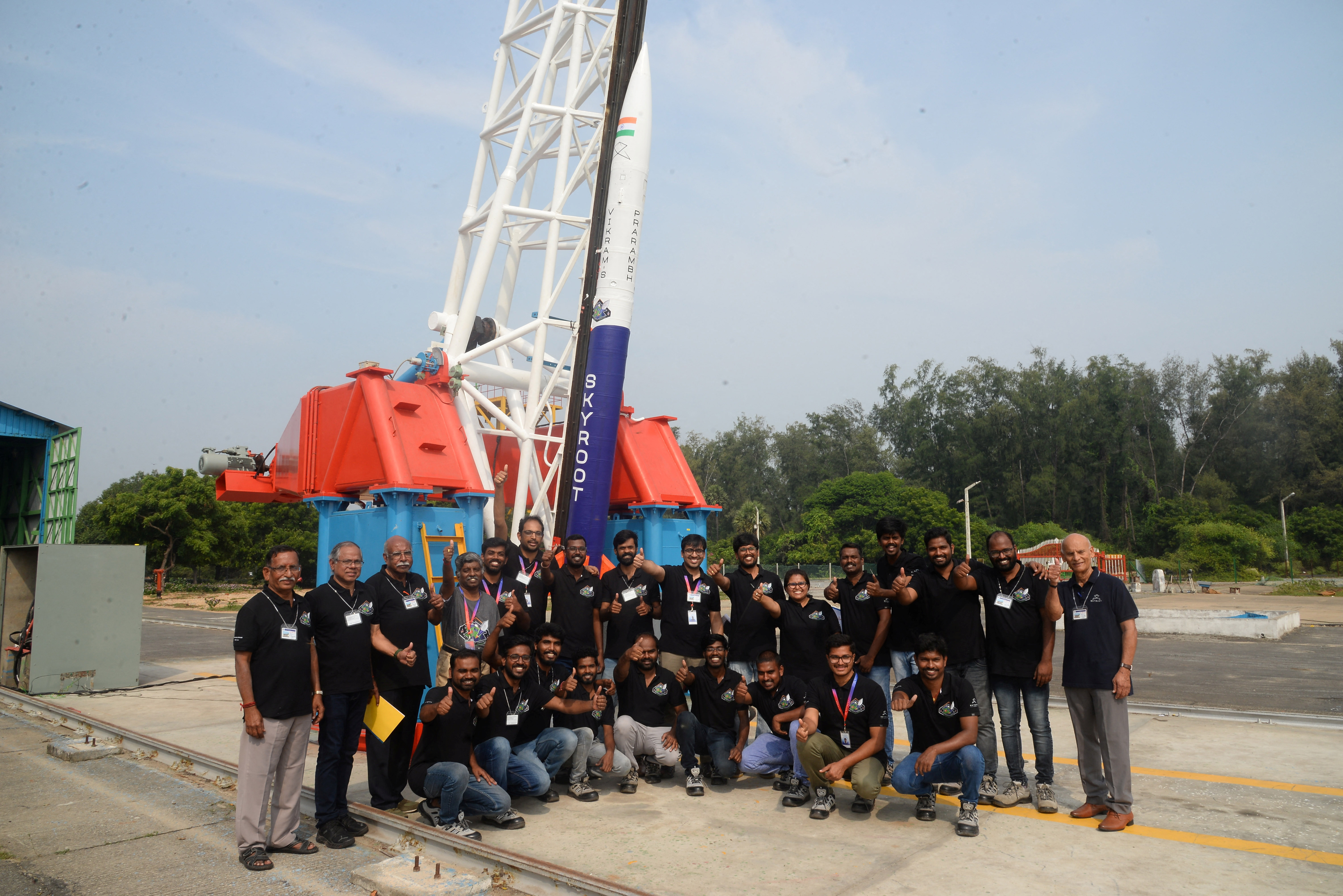 Employees pose in front of Vikram-S rocket at a spaceport in Sriharikota