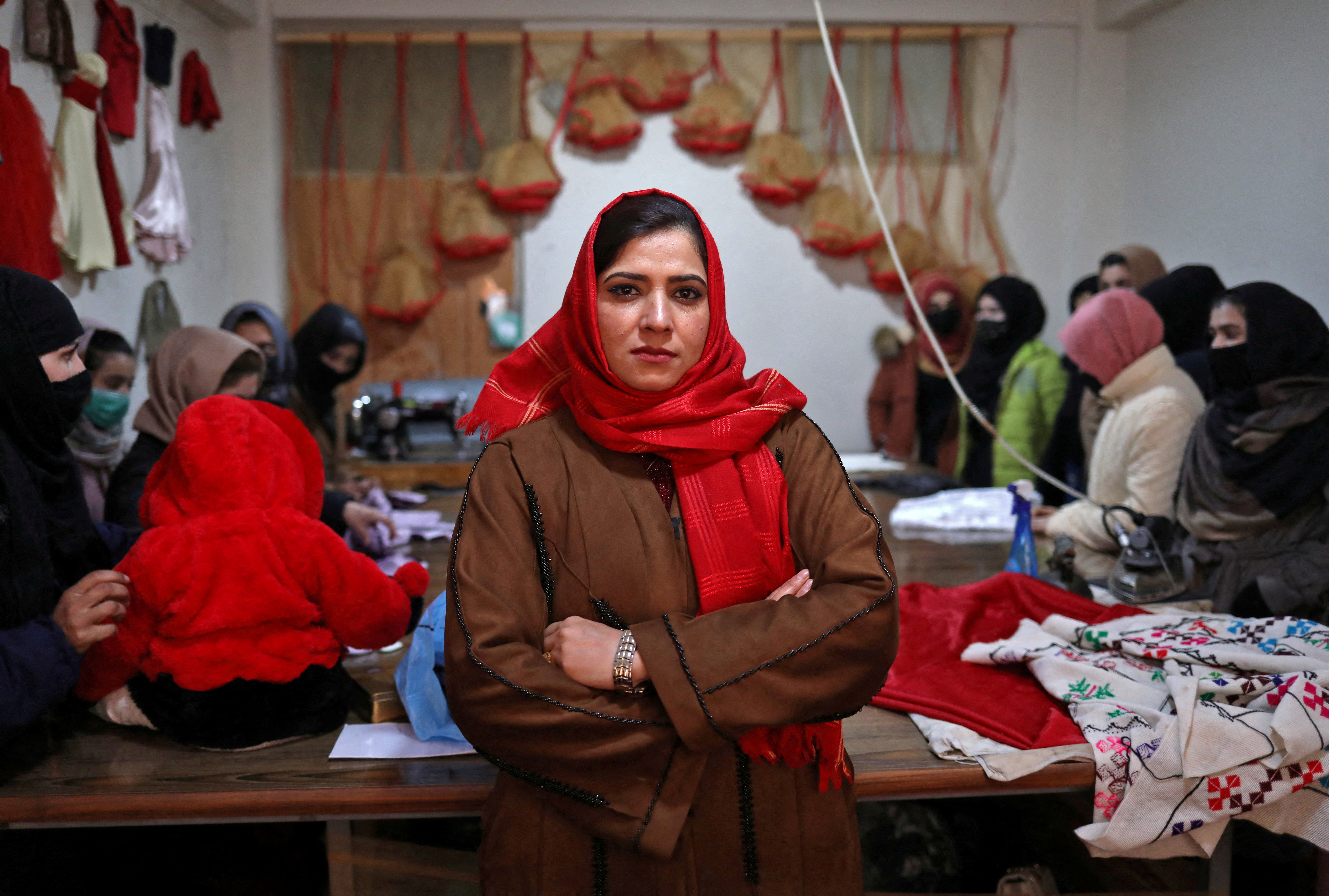 Sohaila Noori, 29, owner of a sewing workshop, poses at her workshop in Kabul, Afghanistan January 15, 2022. REUTERS/Ali Khara