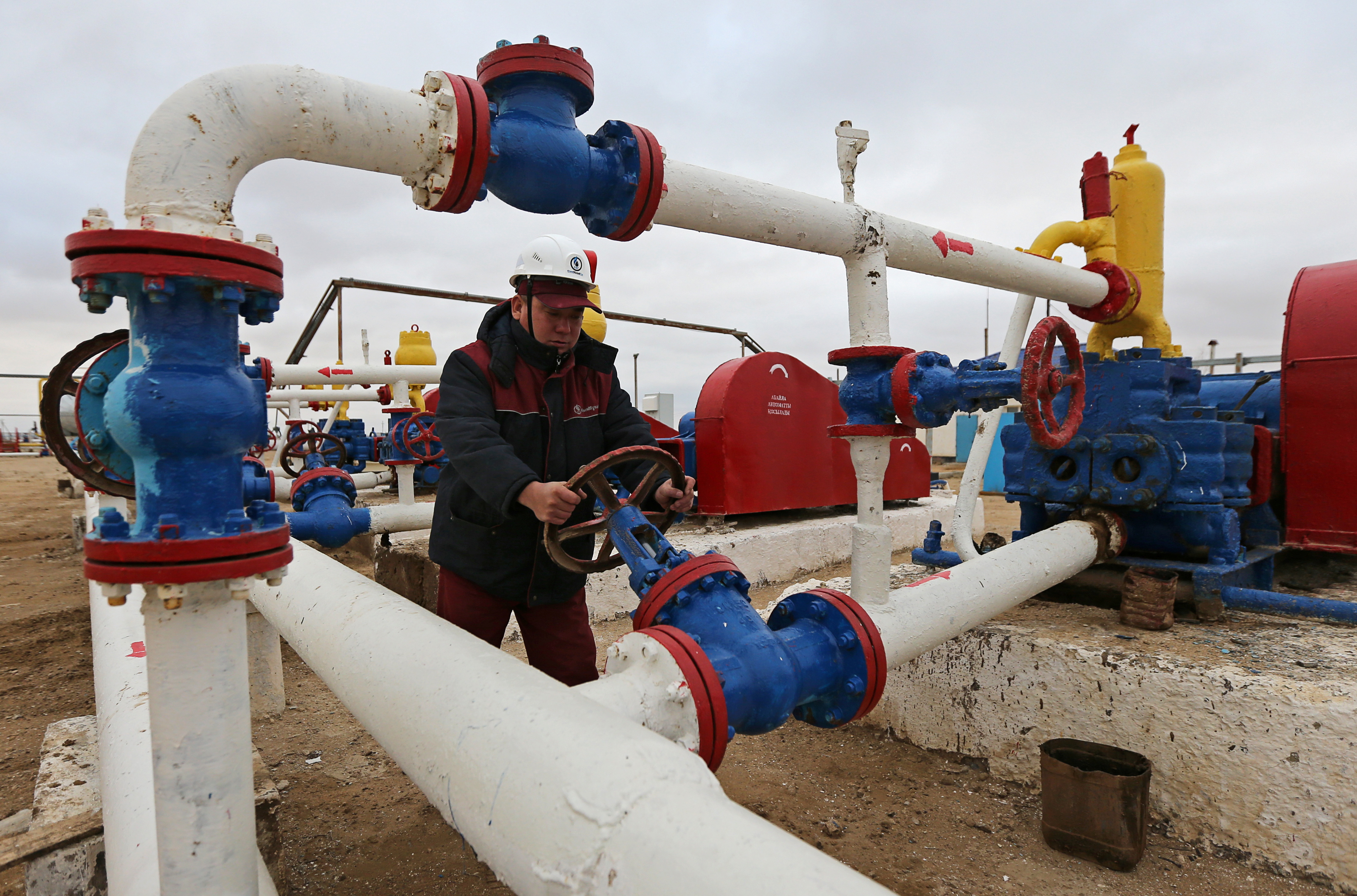 A worker checks the pressure of pumps at an oil-pumping station in the Uzen oil and gas field in the Mangistau Region