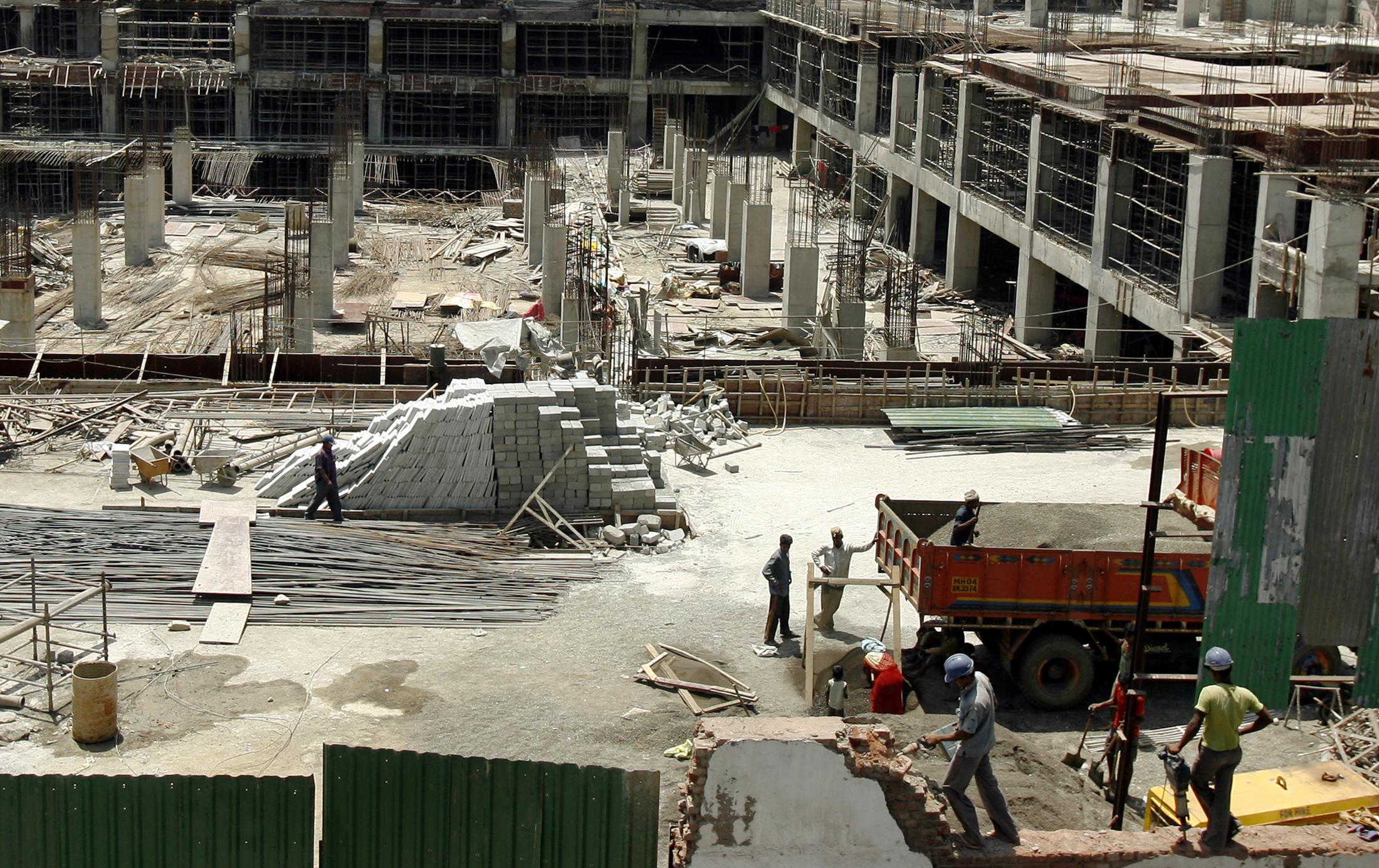 Labourers work at the construction site of a building in Mumbai