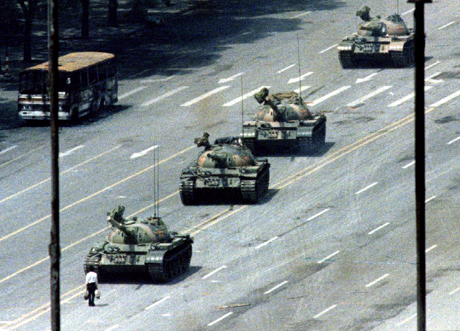 FILE PHOTO 5JUN89 - A Peking citizen stands passively in front of a convoy of tanks on the Avenue of..