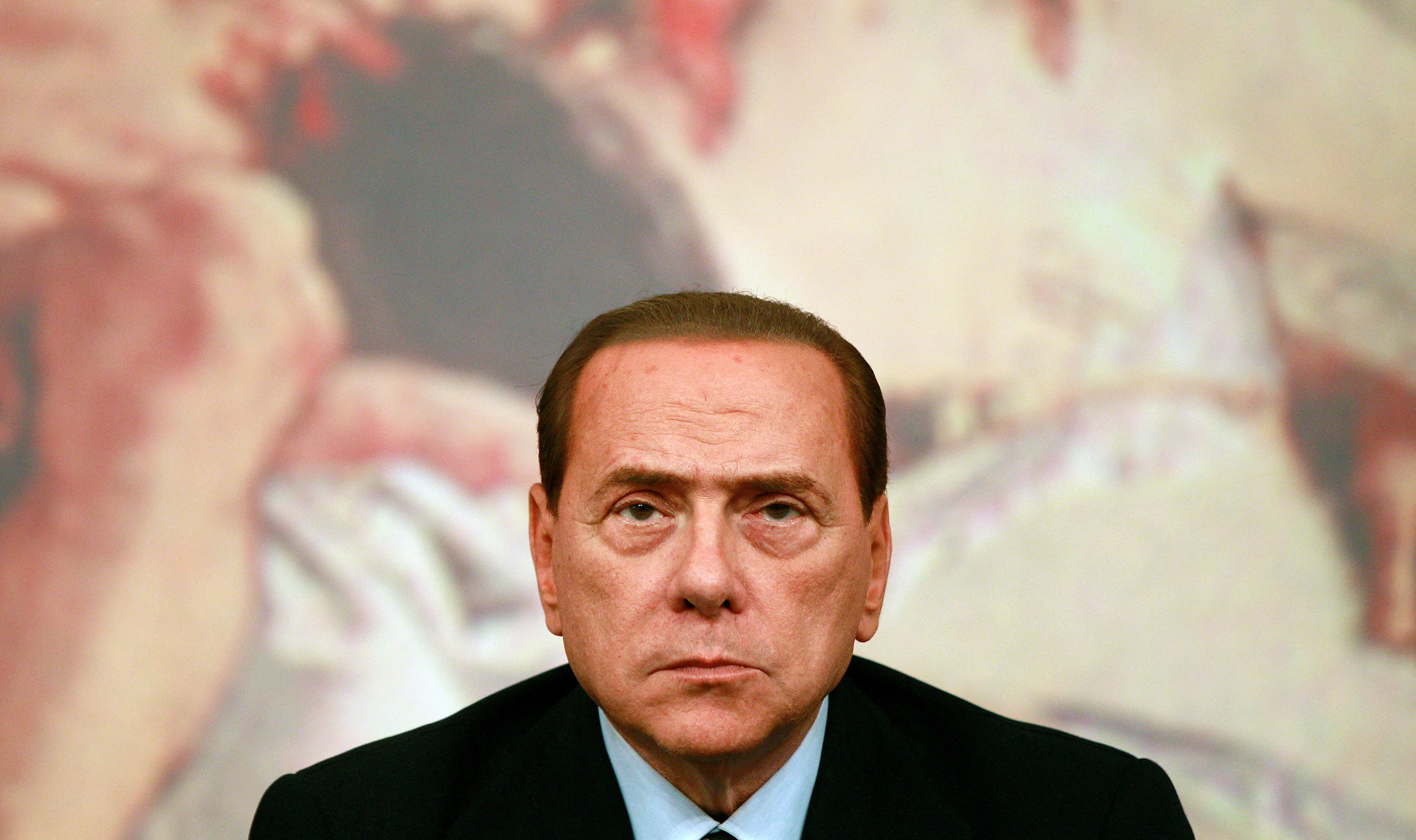 Italy's Prime Minister Berlusconi looks on during a news conference at Chigi Palace in Rome