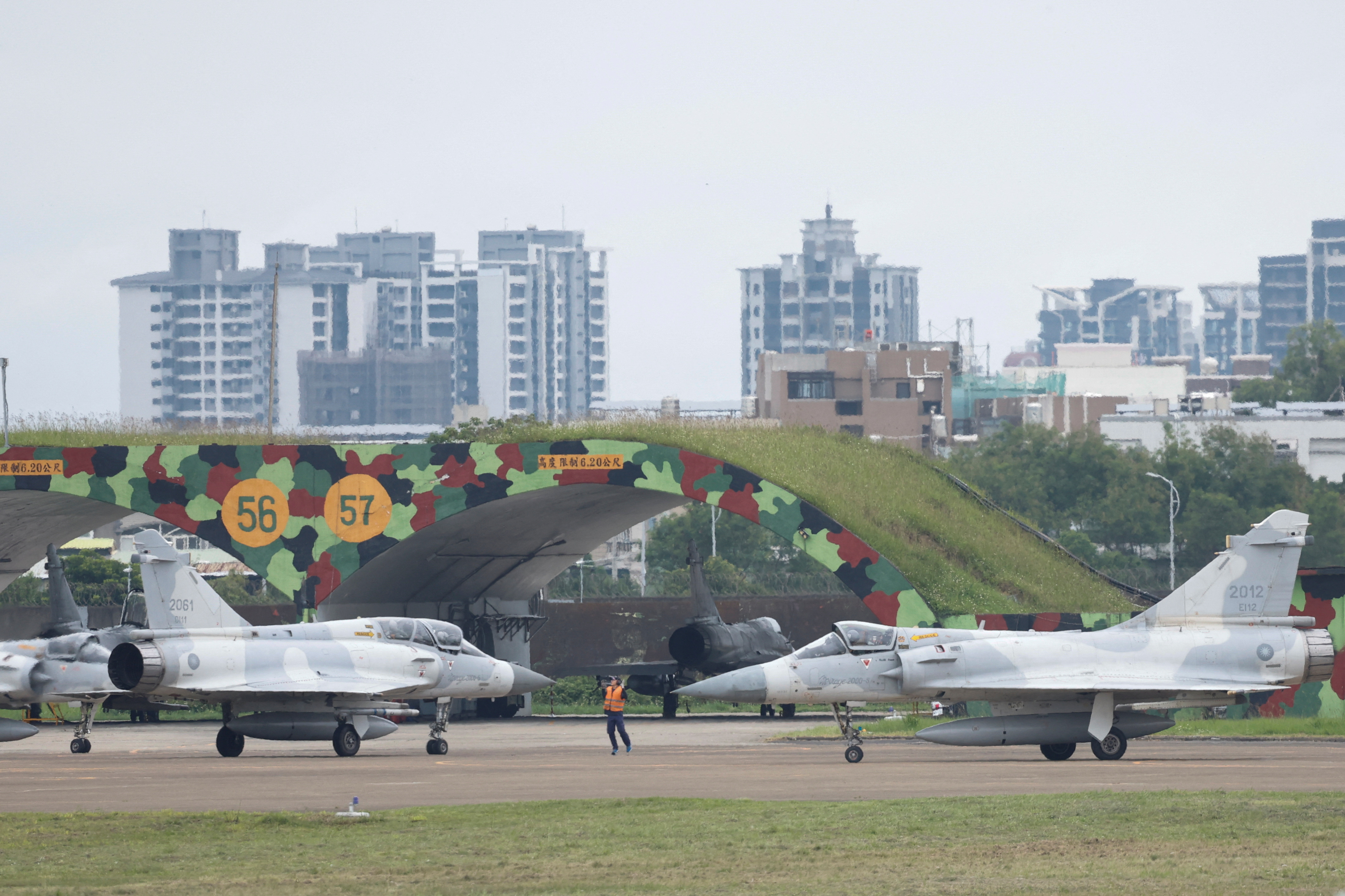 A ground staff gesture to Taiwan Air Force Mirage 2000-5 aircraft as preparing to take off at Hsinchu Air Base, in Hsinchu