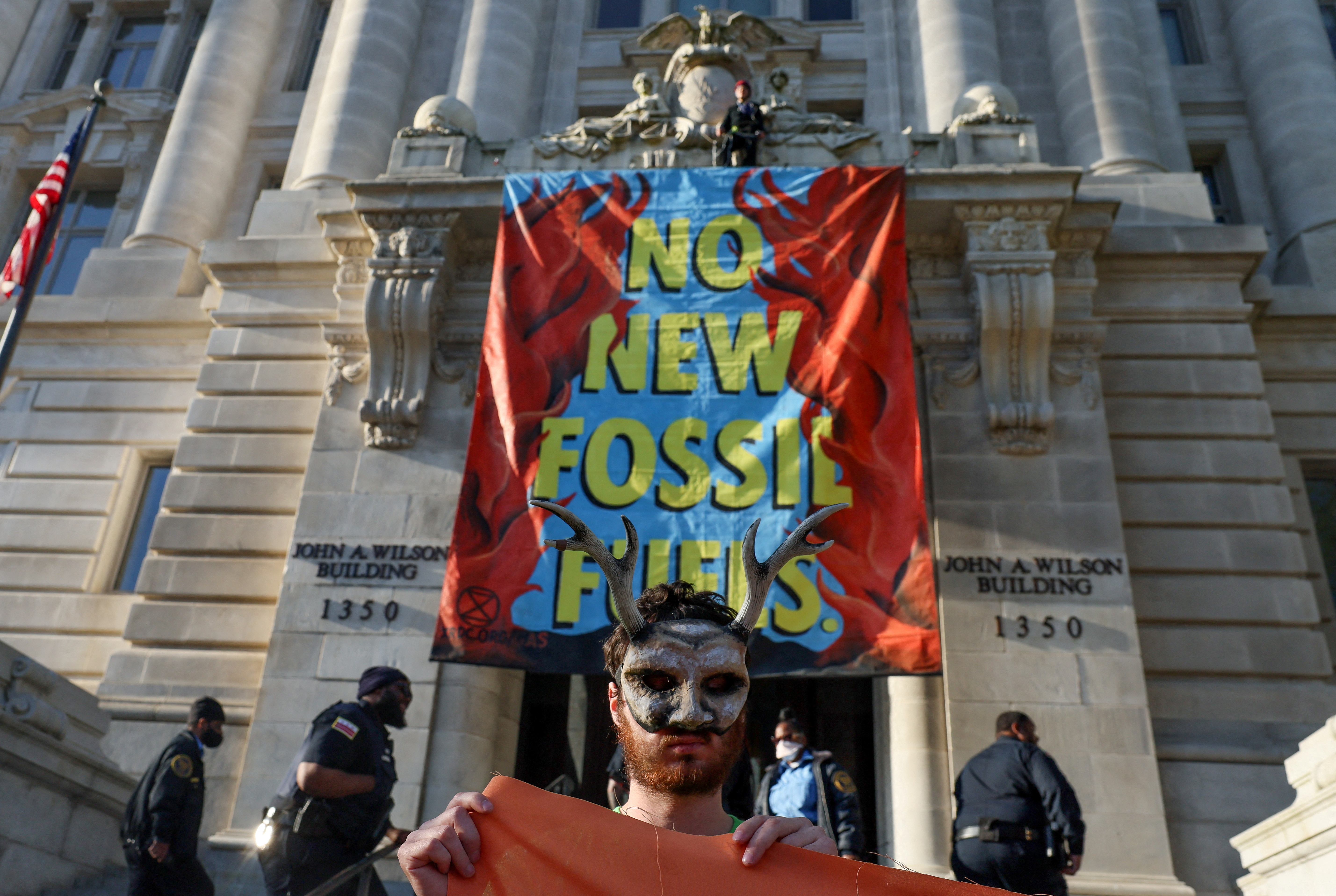 Activists from the climate group Extinction Rebellion demand an end to all new fossil fuel infrastructure on Earth Day in Washington