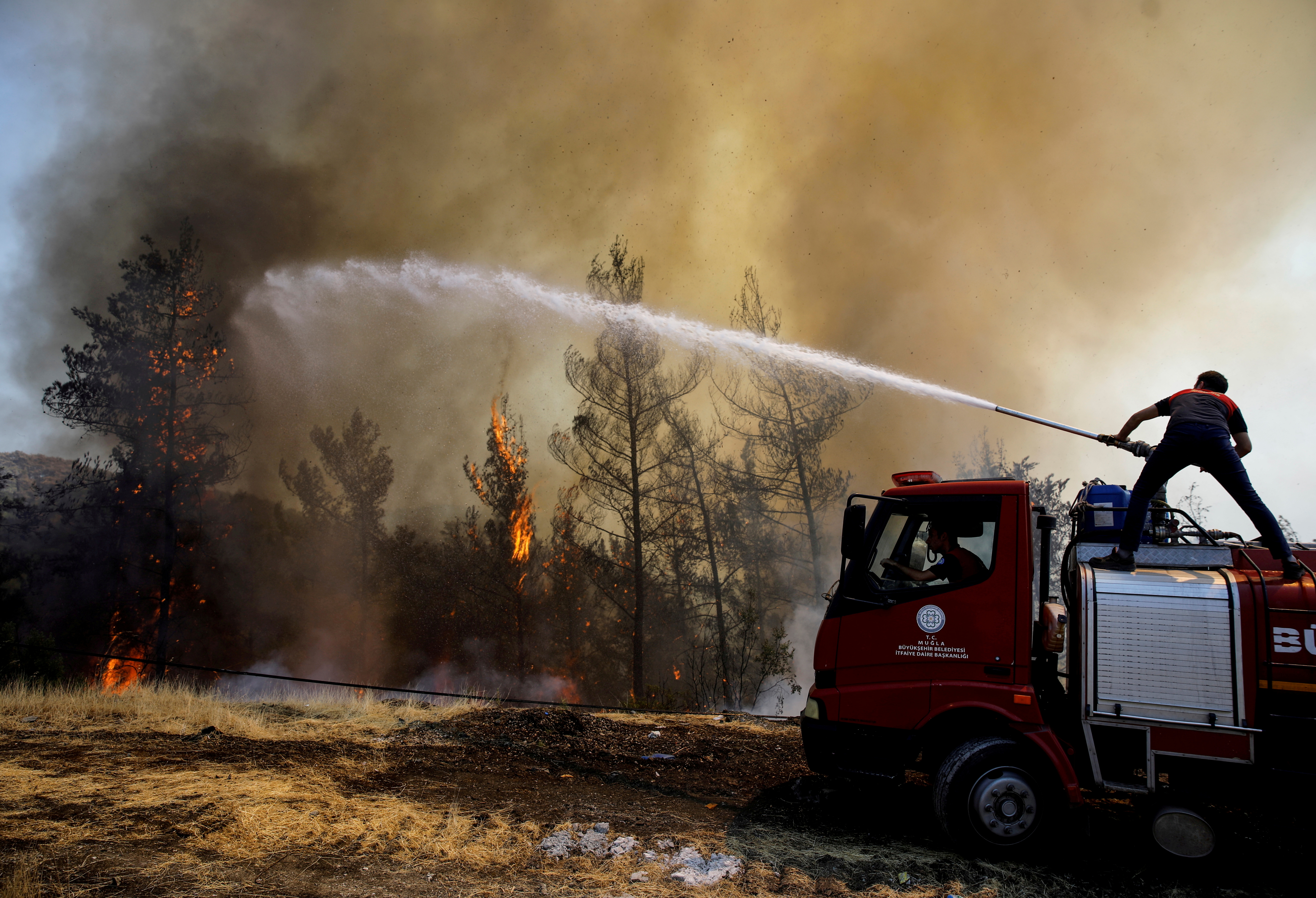 A firefighter tries to extinguish a wildfire near Marmaris, Turkey, August 1,
