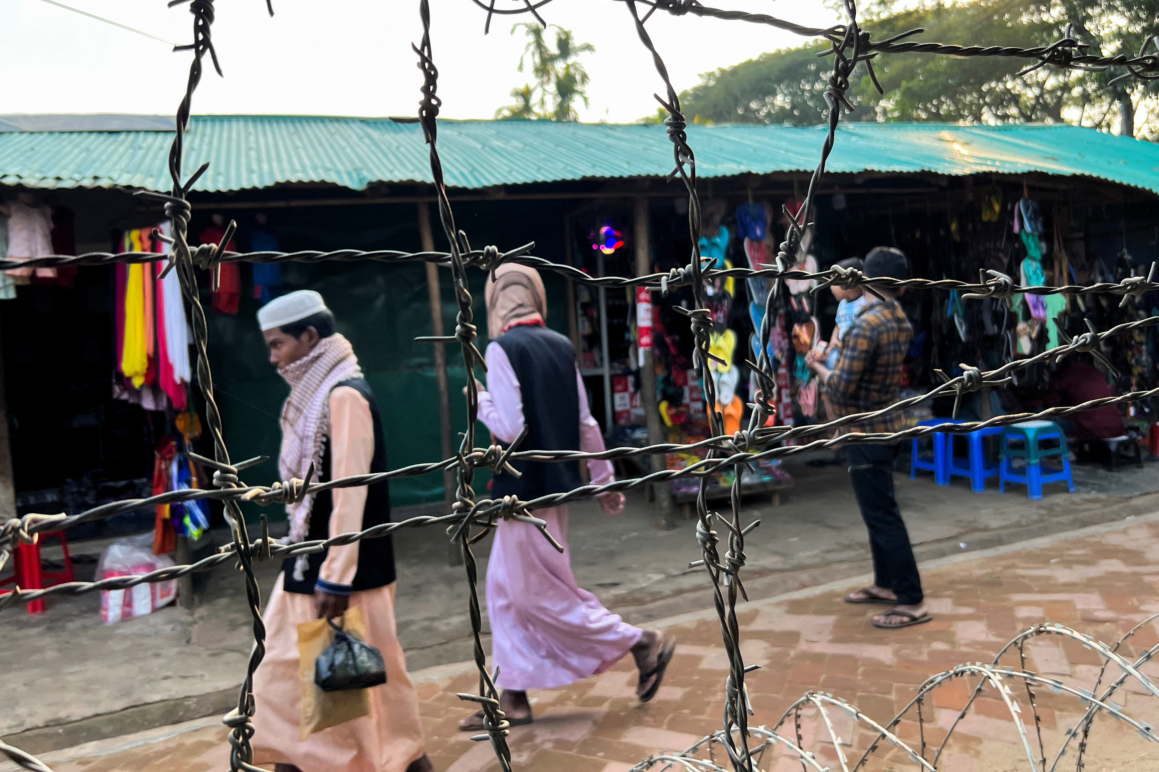 Barbed wire is seen on the side of a refugee camp in Cox's Bazar