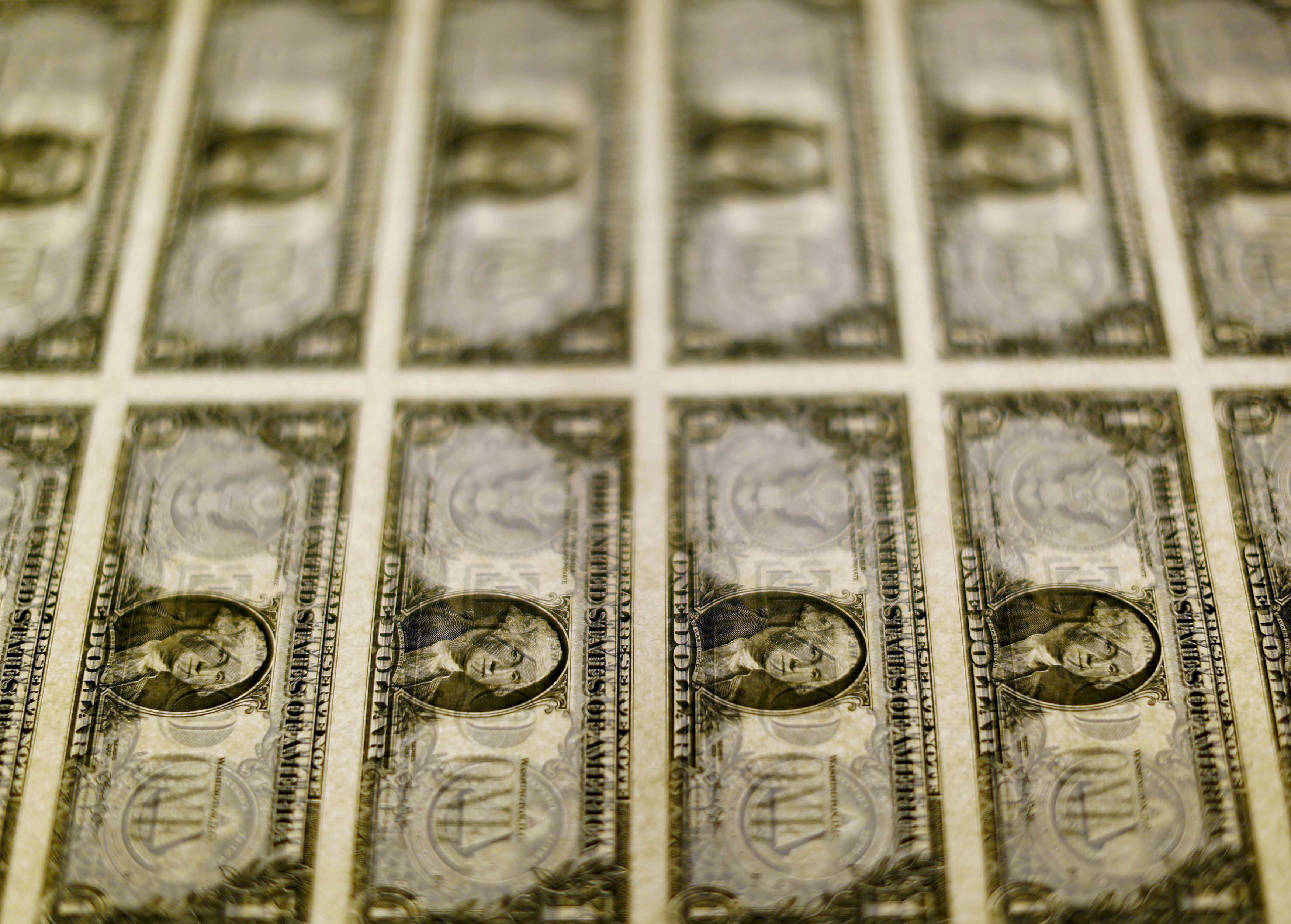U.S. dollar bills are seen on a light table at the Bureau of Engraving and Printing in Washington