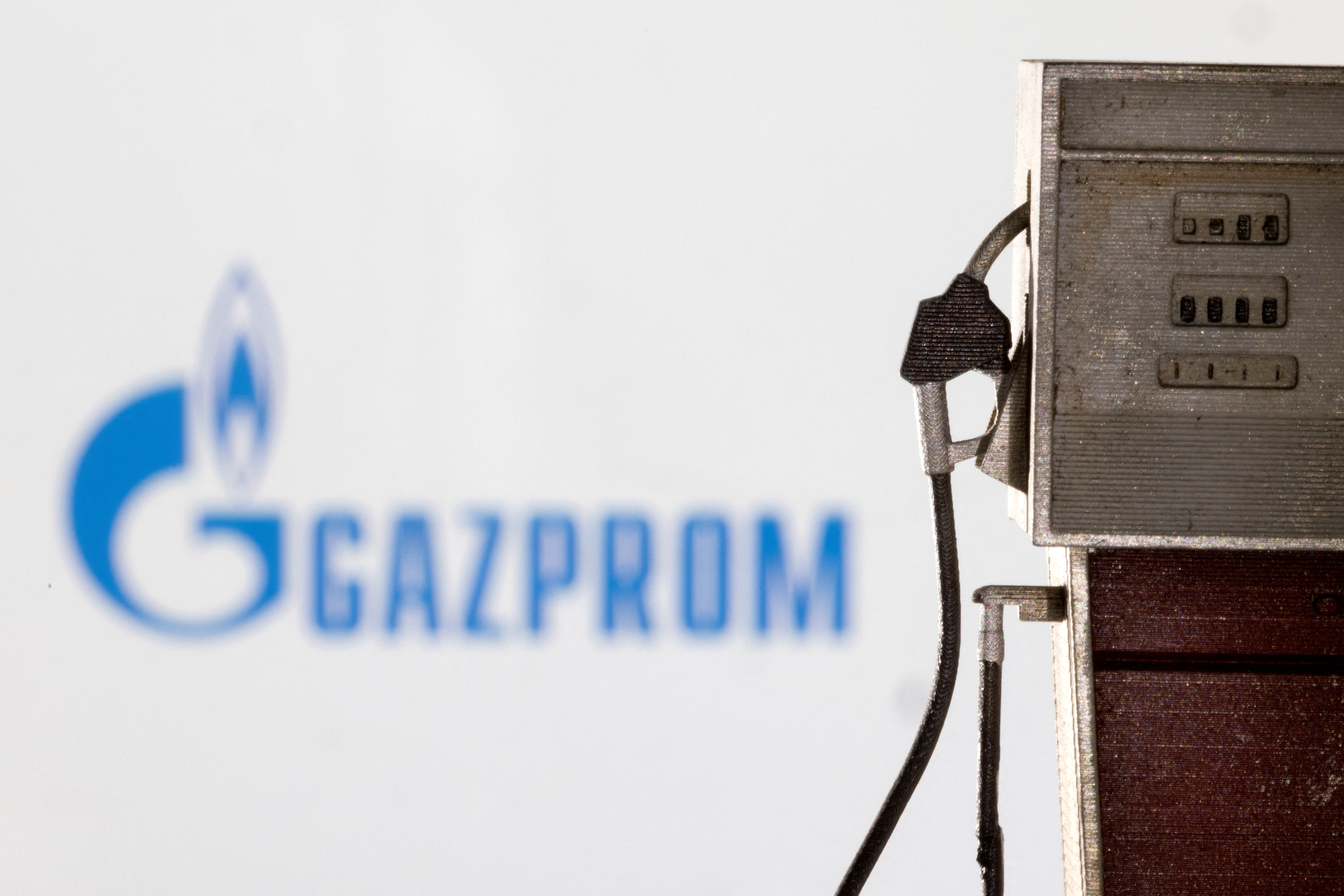 Illustration shows model of petrol pump and Gazprom logo