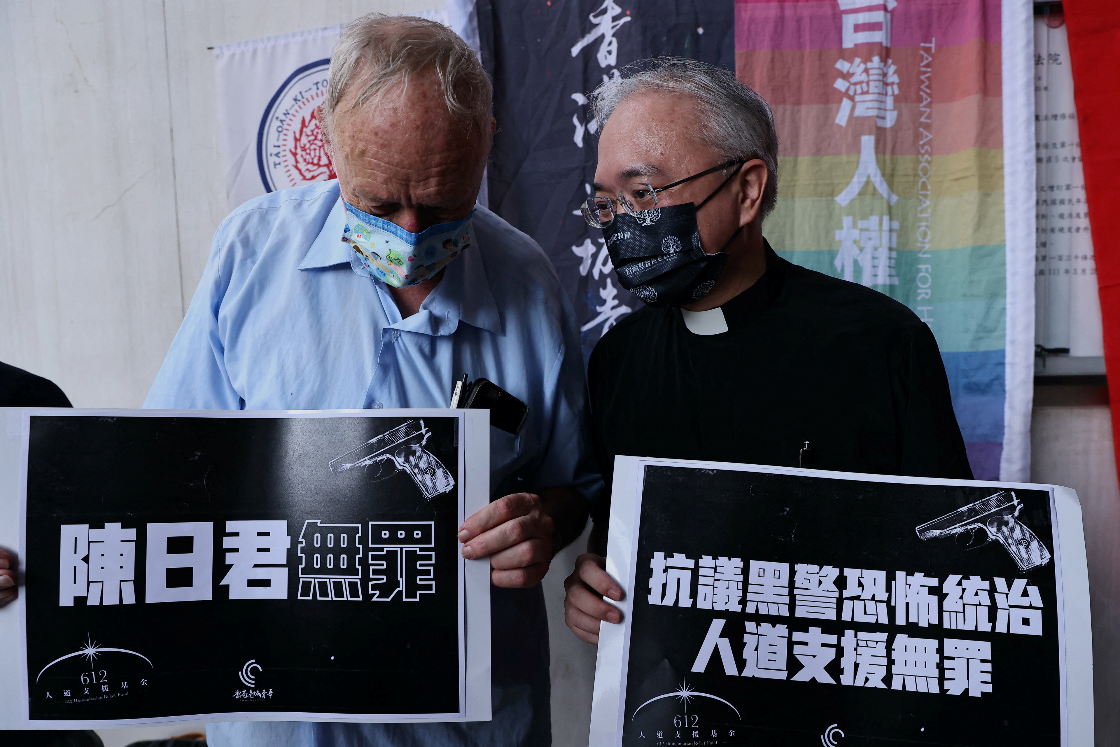 Taiwanese priests Ollevier Willy and Huang Chuan-sheng protest against the arrests of veteran democracy advocates
