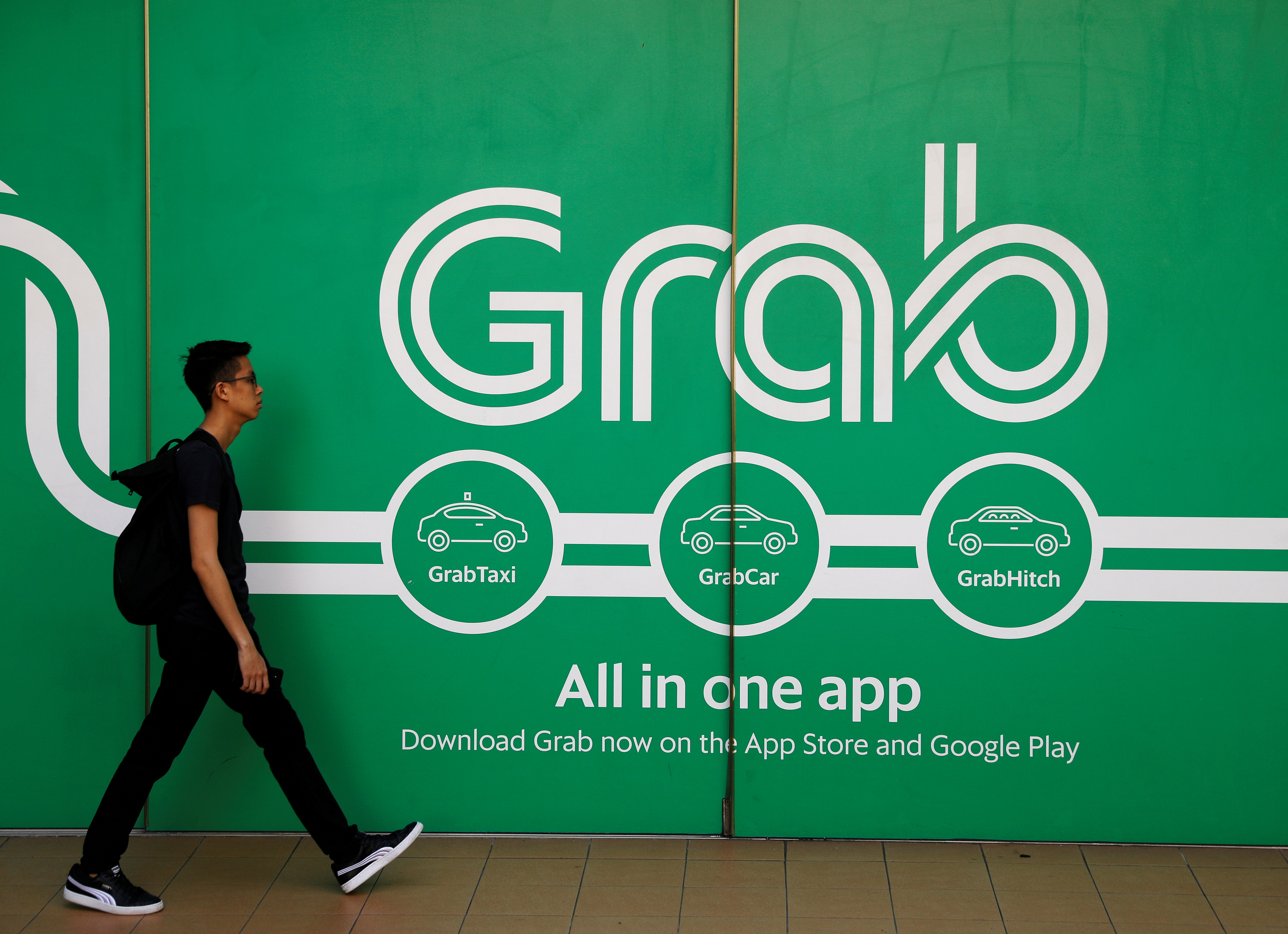 A man walks past a Grab office in Singapore