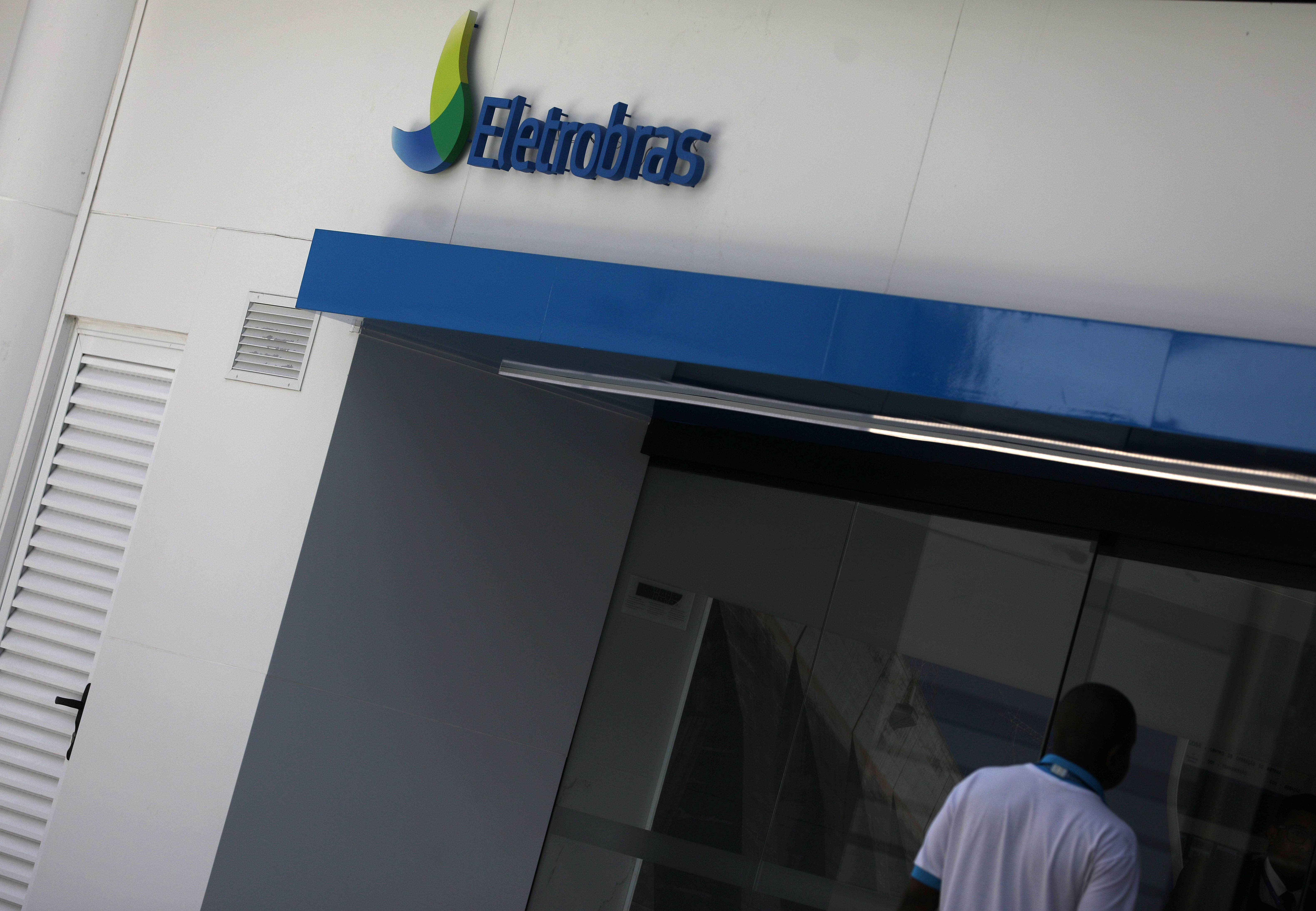 A person walks past in front of the headquarters of Brazil's power company Eletrobras in Rio de Janeiro