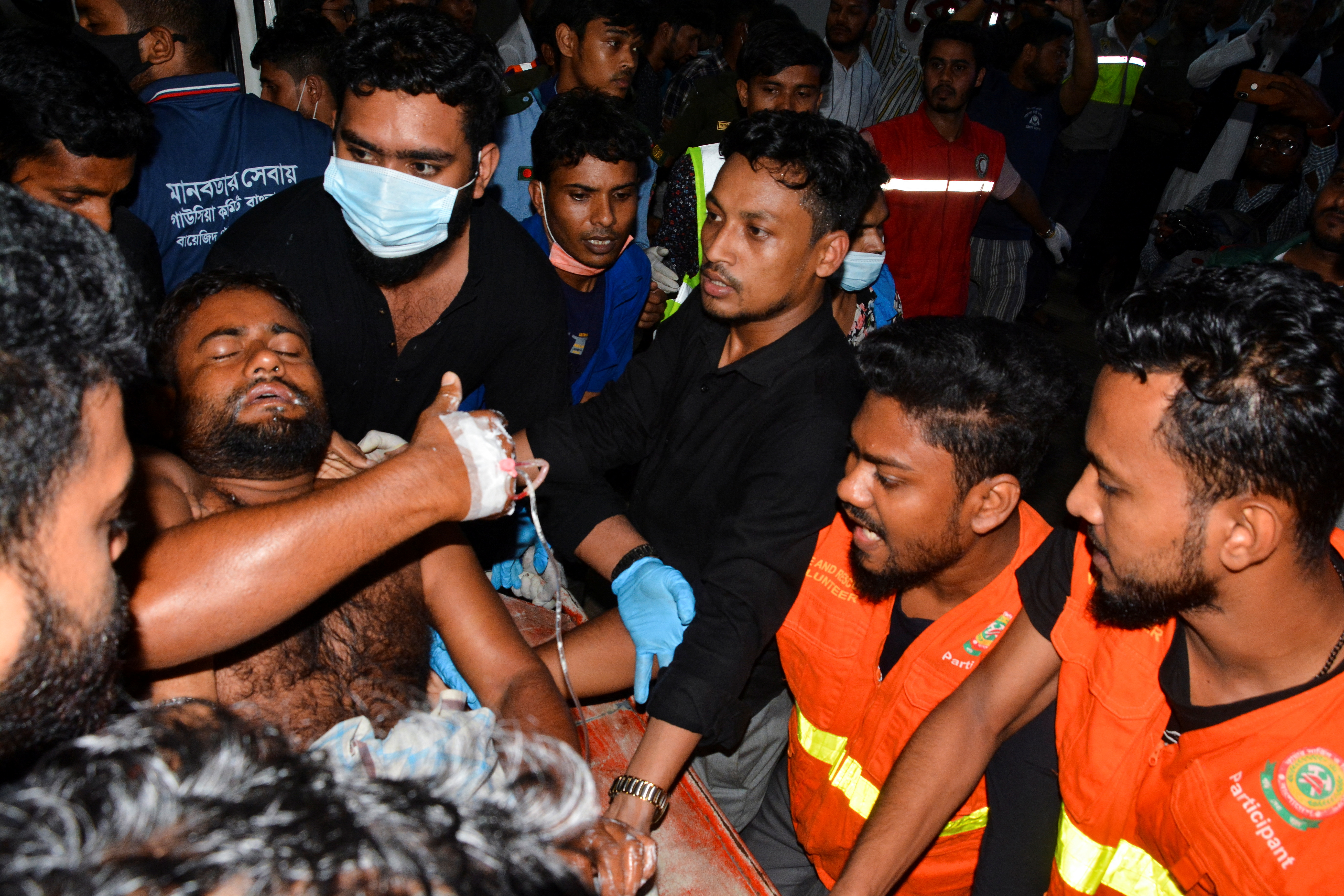 An injured victim is brought to a hospital after a massive fire broke out in an inland container depot at Sitakund, near the port city Chittagong