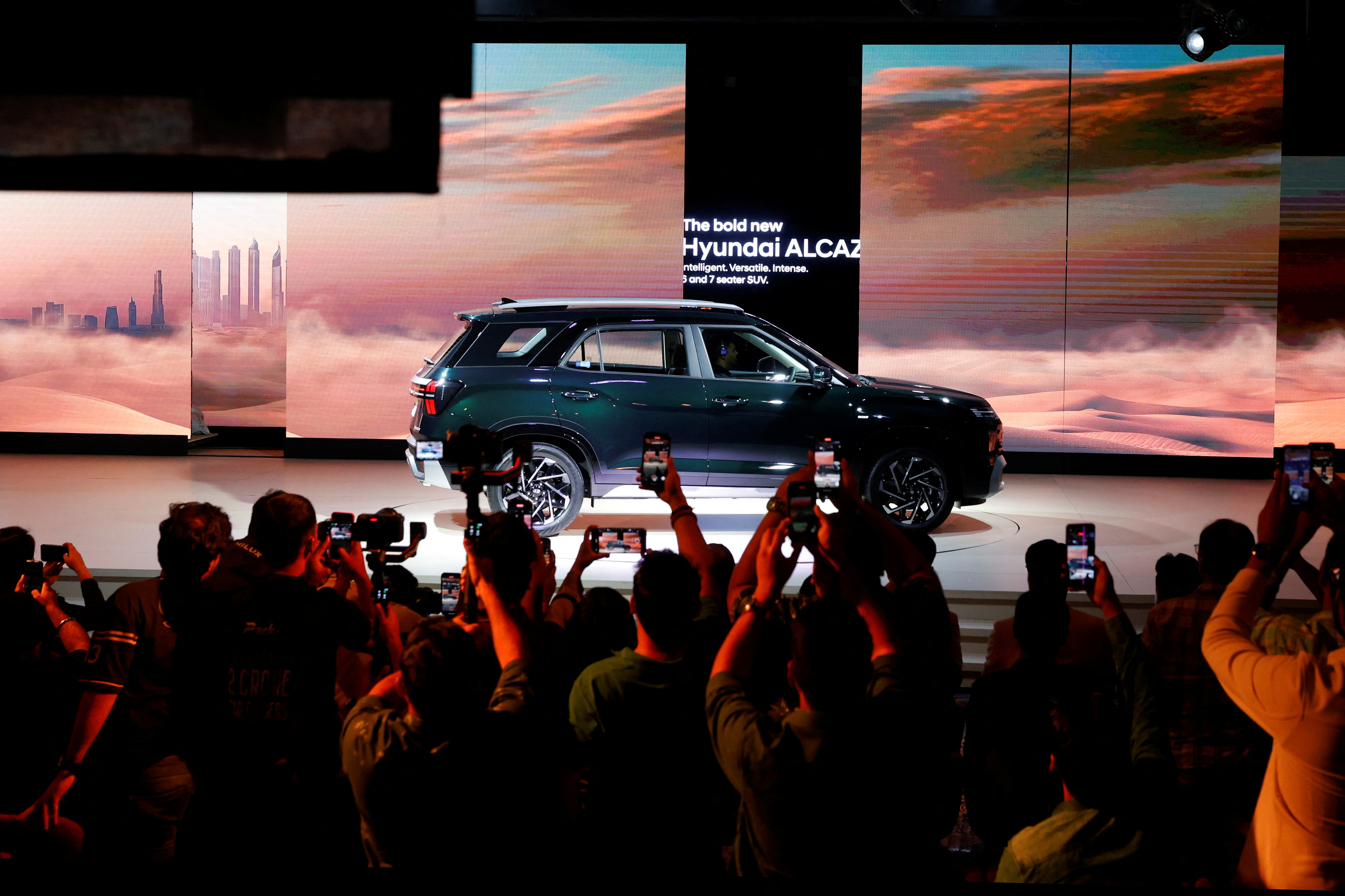 Visitors use their mobile phones to film the new Hyundai Alcazar in New Delhi