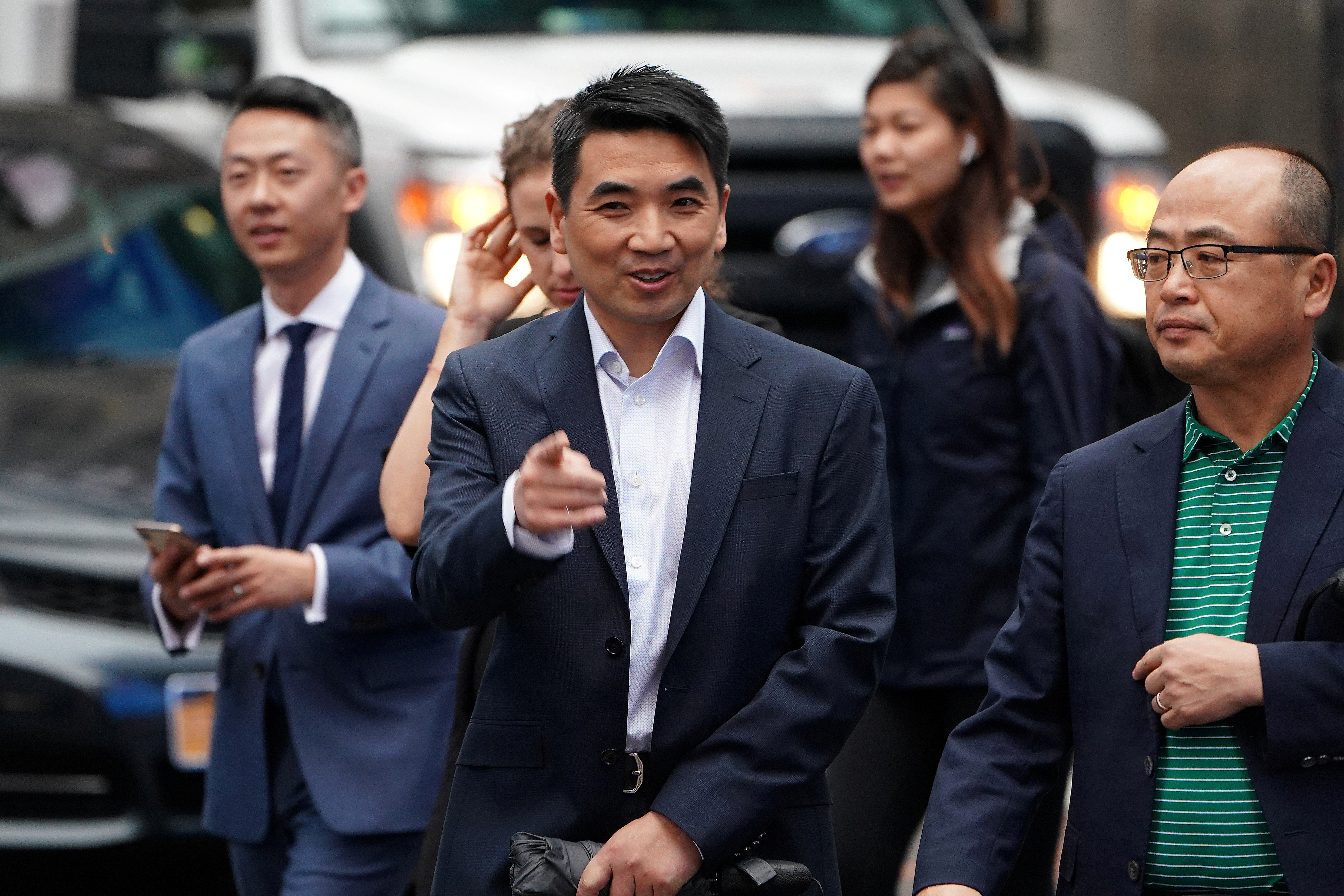 Eric Yuan, CEO of Zoom Video Communications walks on the street as he takes part in a bell ringing ceremony at the NASDAQ MarketSite in New York