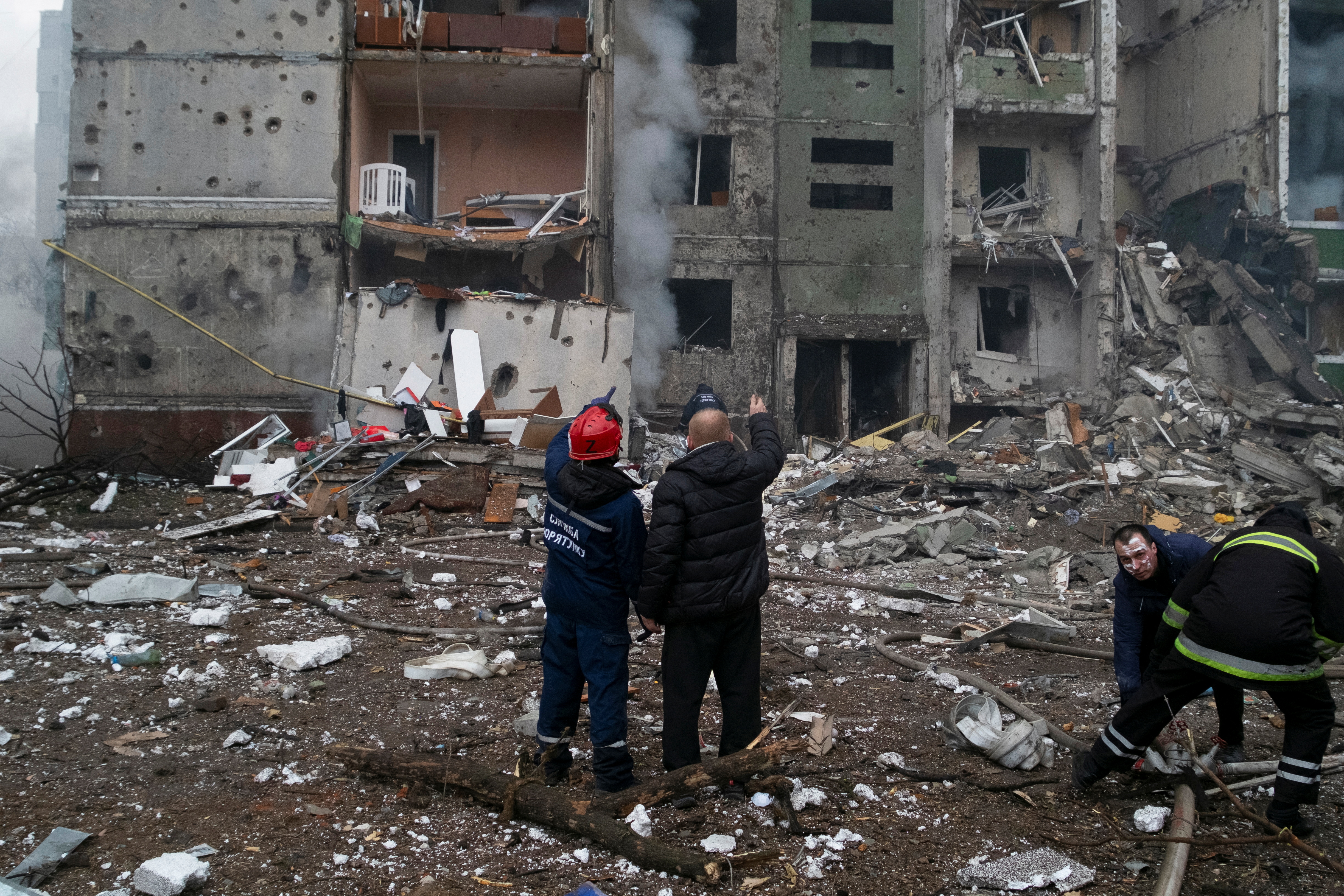Rescuers work at a residential building damaged by recent shelling in Chernihiv