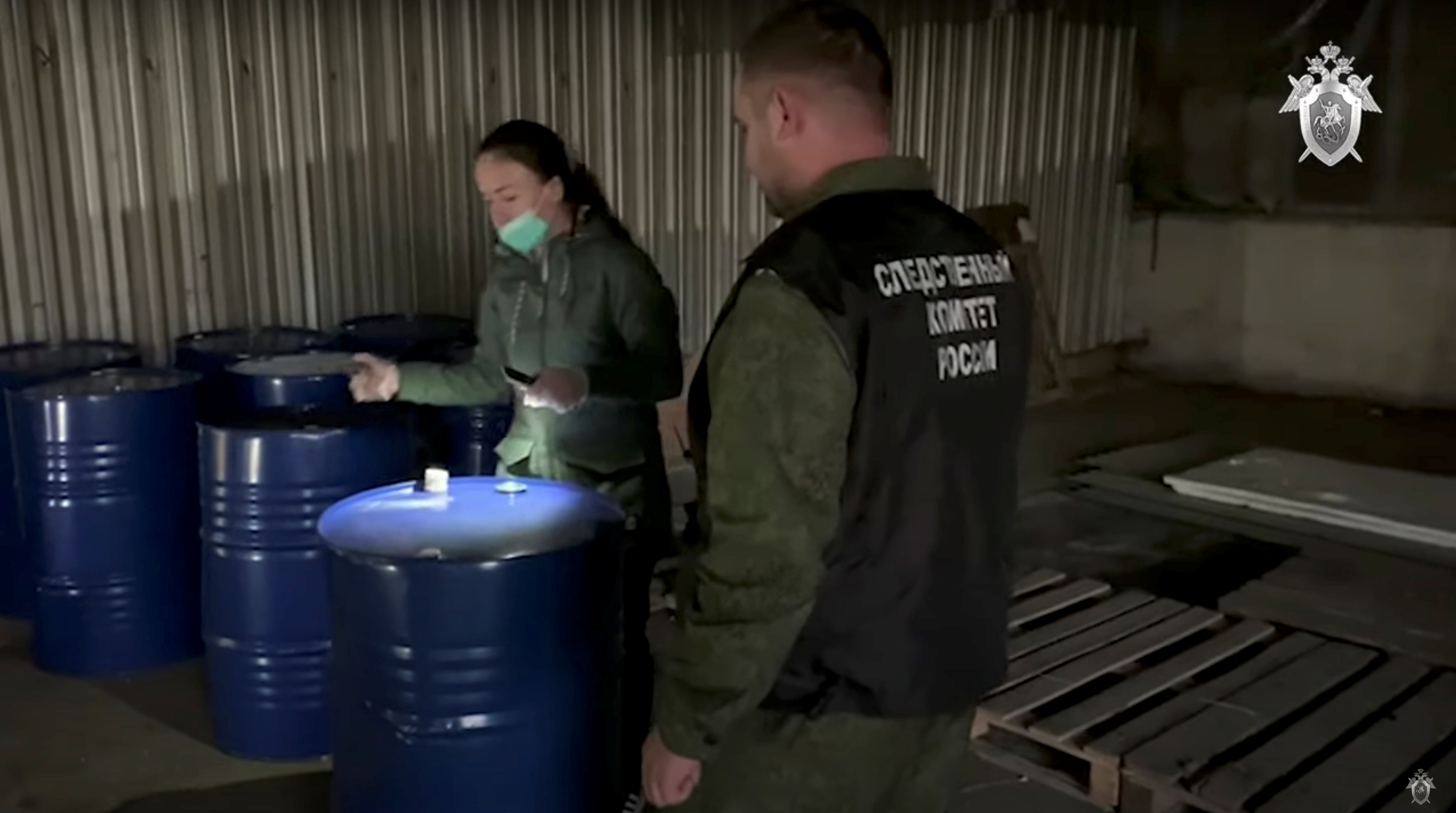 Members of the Russian Investigative Committee investigate a criminal case of deaths of people from alcohol poisoning after consuming locally produced spirits, in Orenburg Region, Russia, in this still image taken from video released October 9, 2021. Investigative Committee of Russia/Handout via REUTERS 