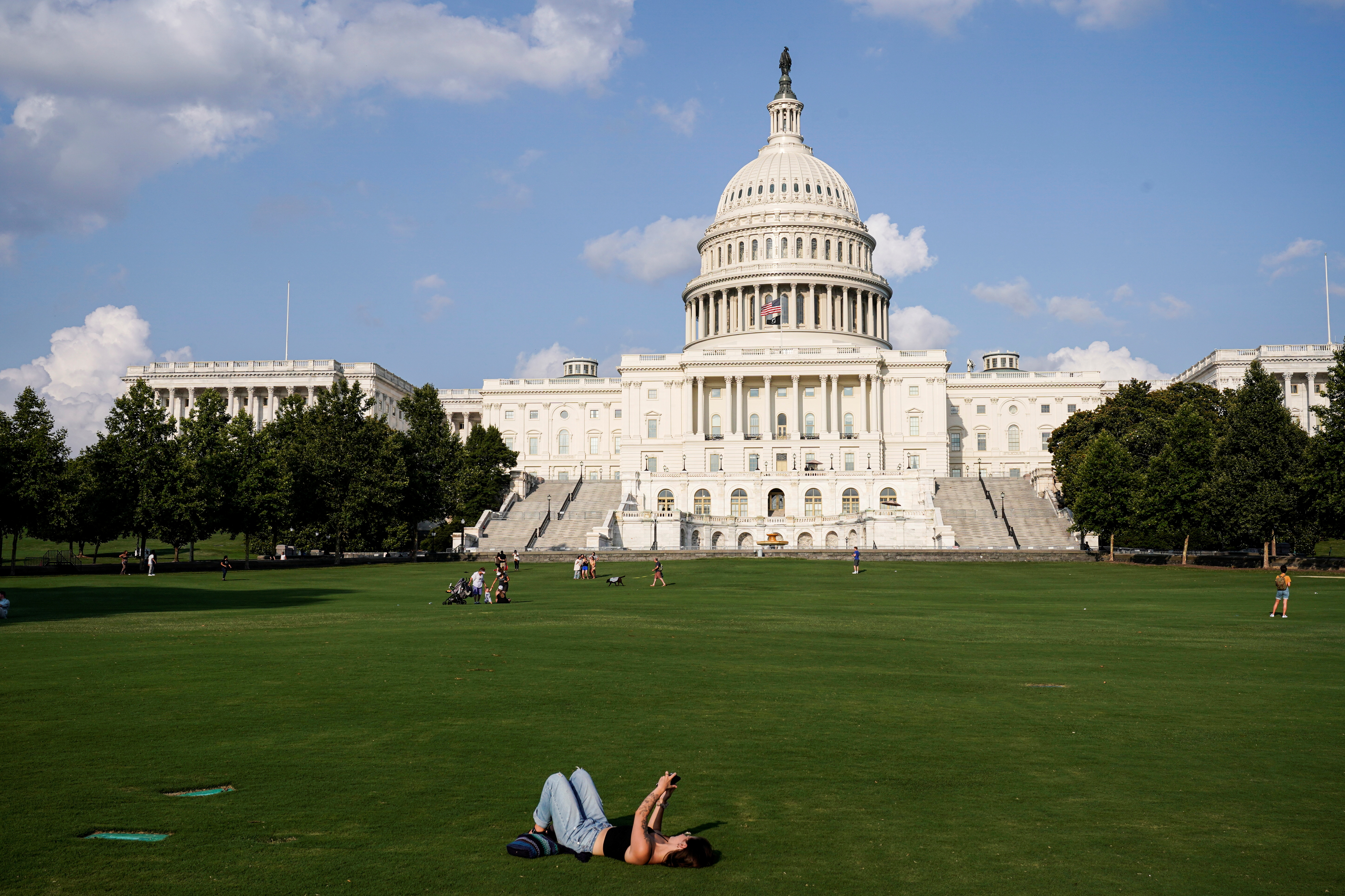 People gather on a lawn at the U.S. Capitol in Washington