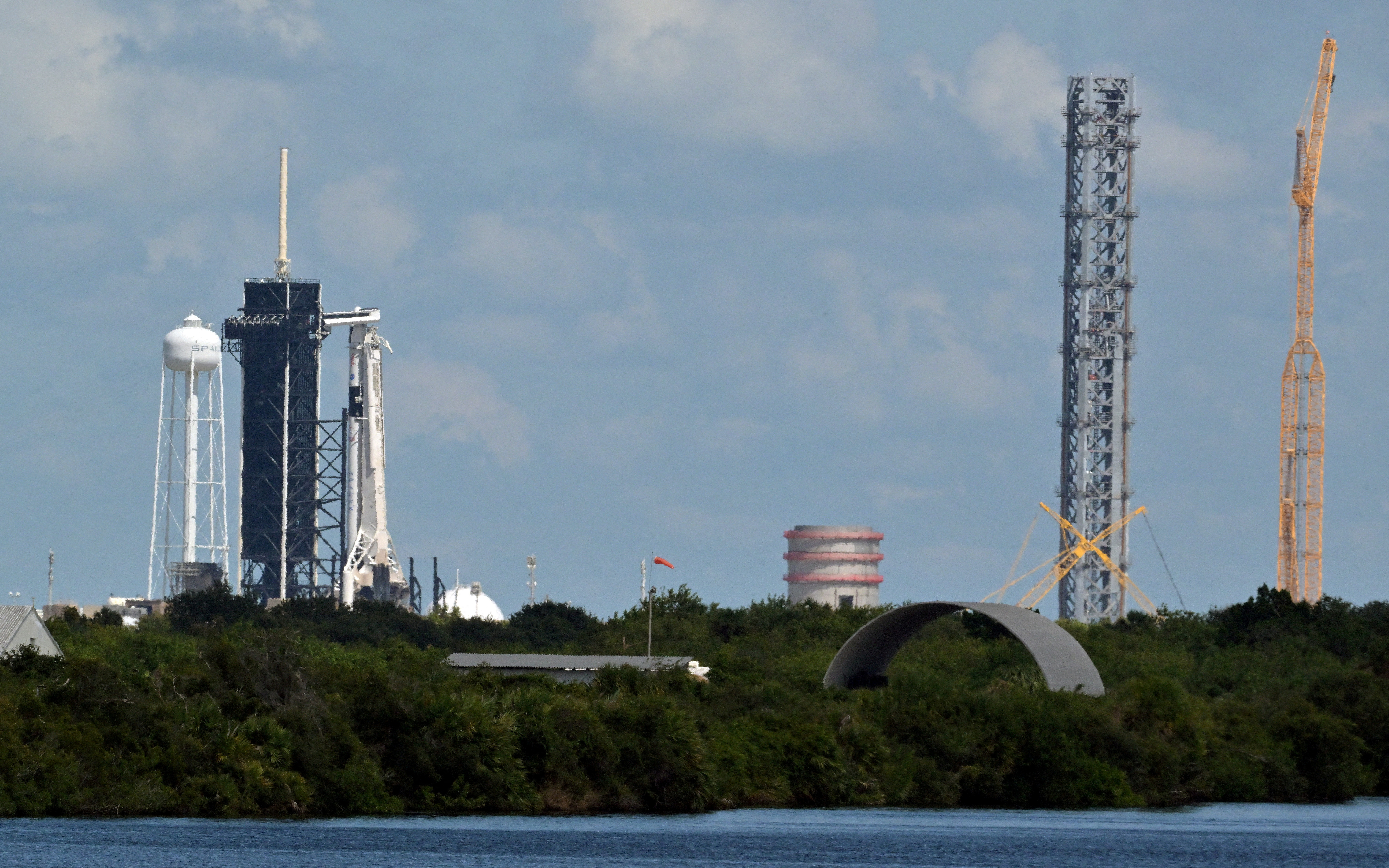 A SpaceX Falcon 9 rocket with the Crew Dragon capsule stands on Pad-39A in preparation for a mission to carry four crew members to the International Space Station