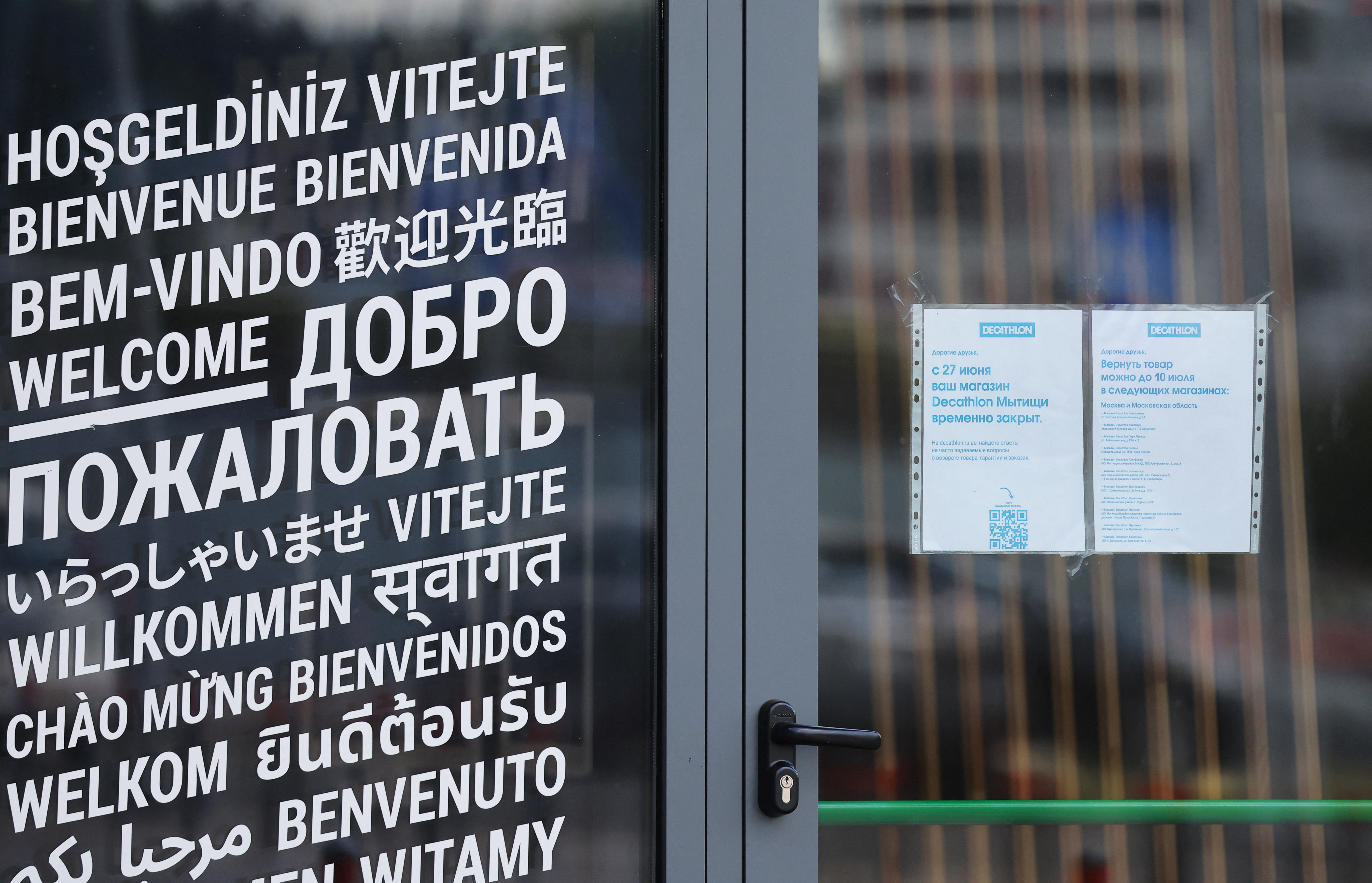 A closing notice is attached to the door of a closed store of the Decathlon sporting goods retailer in Mytishchi