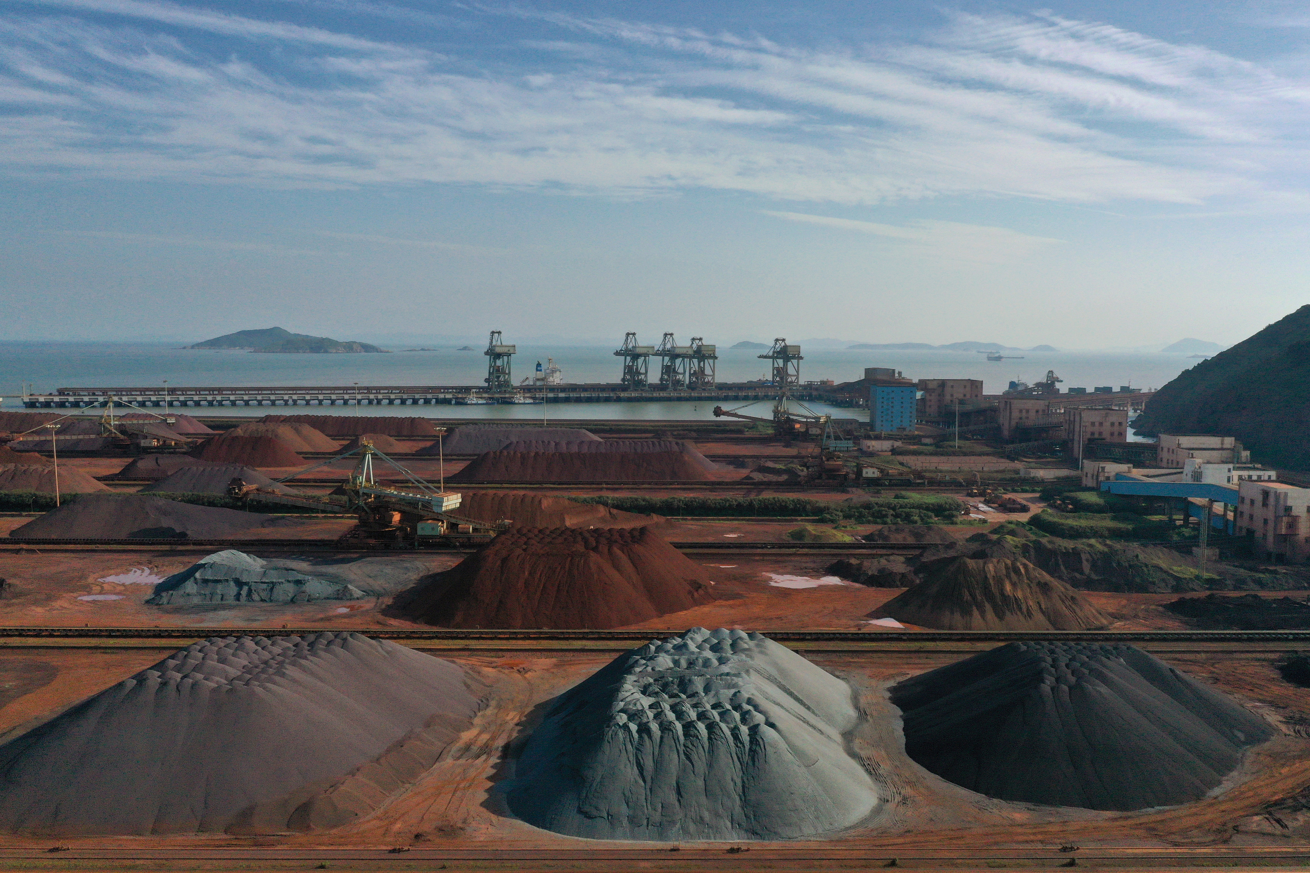 Piles of imported iron ore are seen at a port in Zhoushan, Zhejiang province, China May 9, 2019. REUTERS/Stringer 