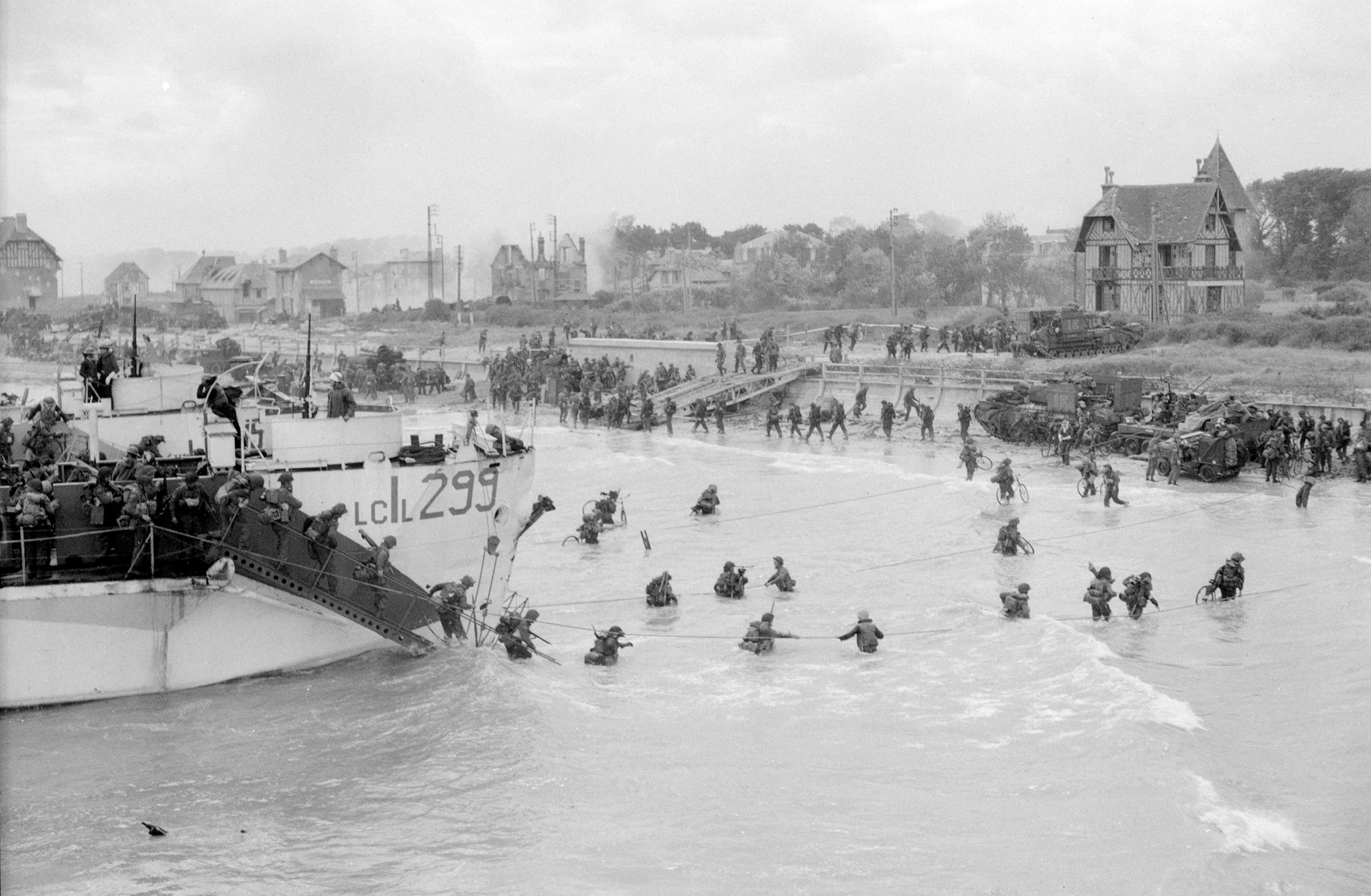 Canadian troops come ashore at a Juno Beach landing area on D-Day at Bernieres Sur Mer, France in this handout photo